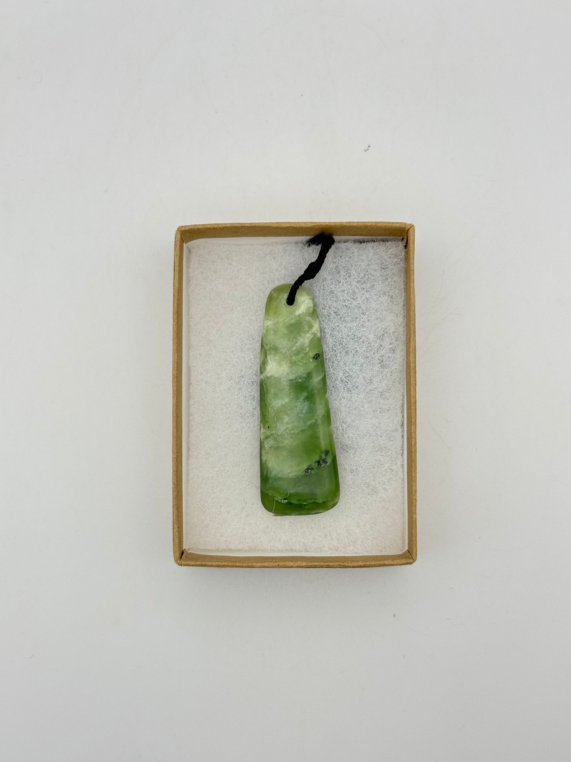 Green Jade pendant with string necklace.