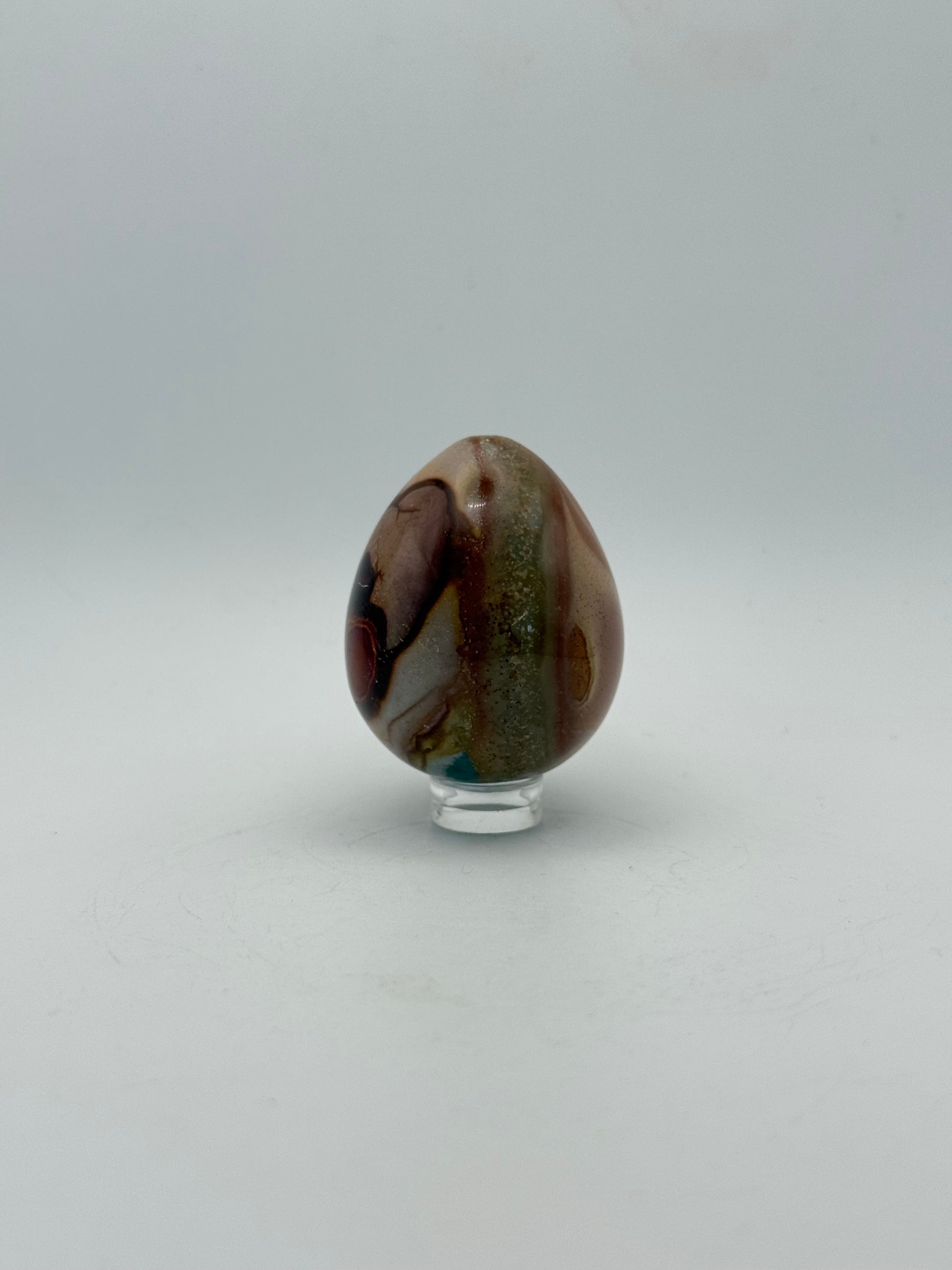 Polished polychrome jasper shaped into an egg.
