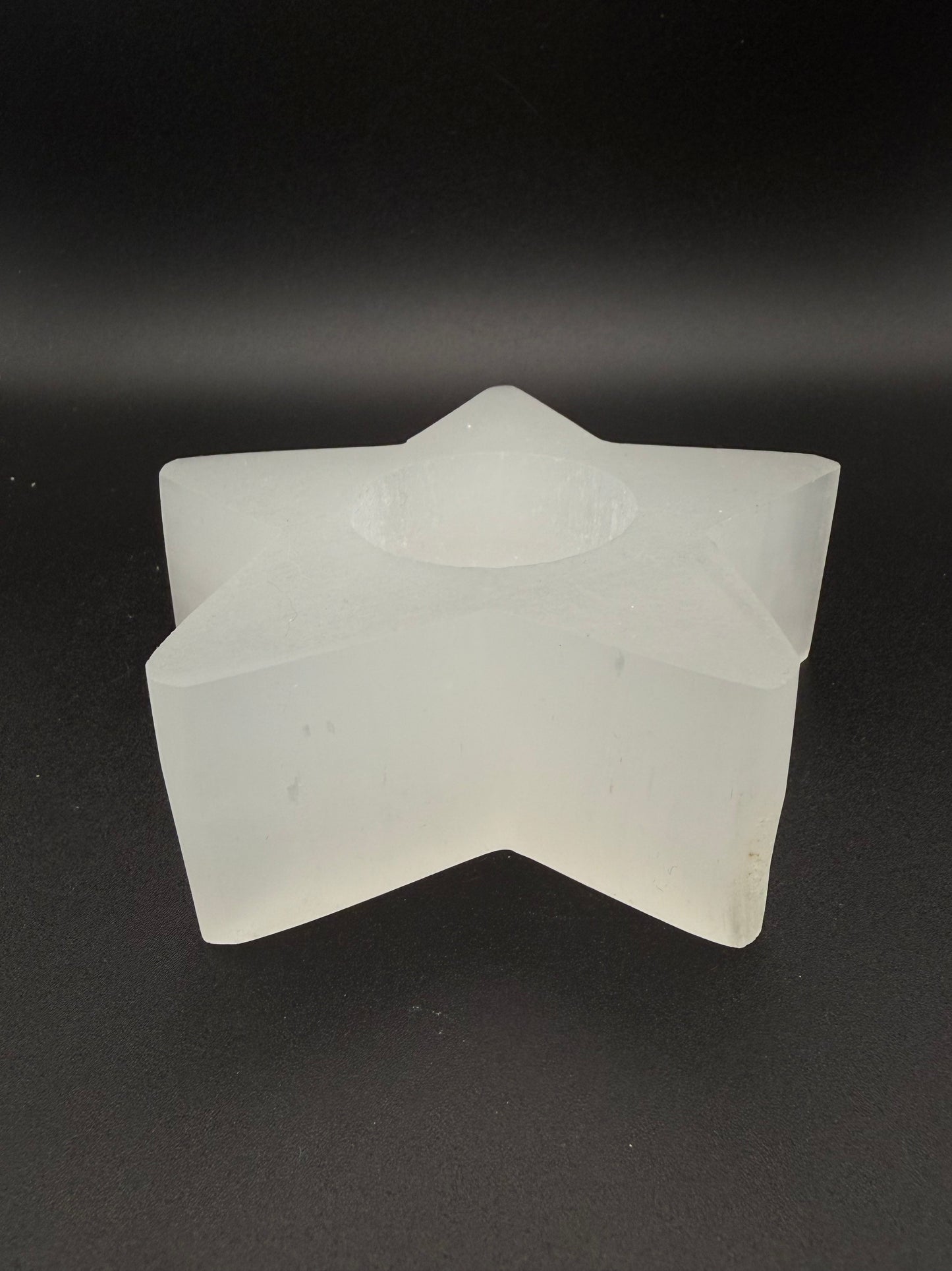 Star-shaped selenite candle holder.