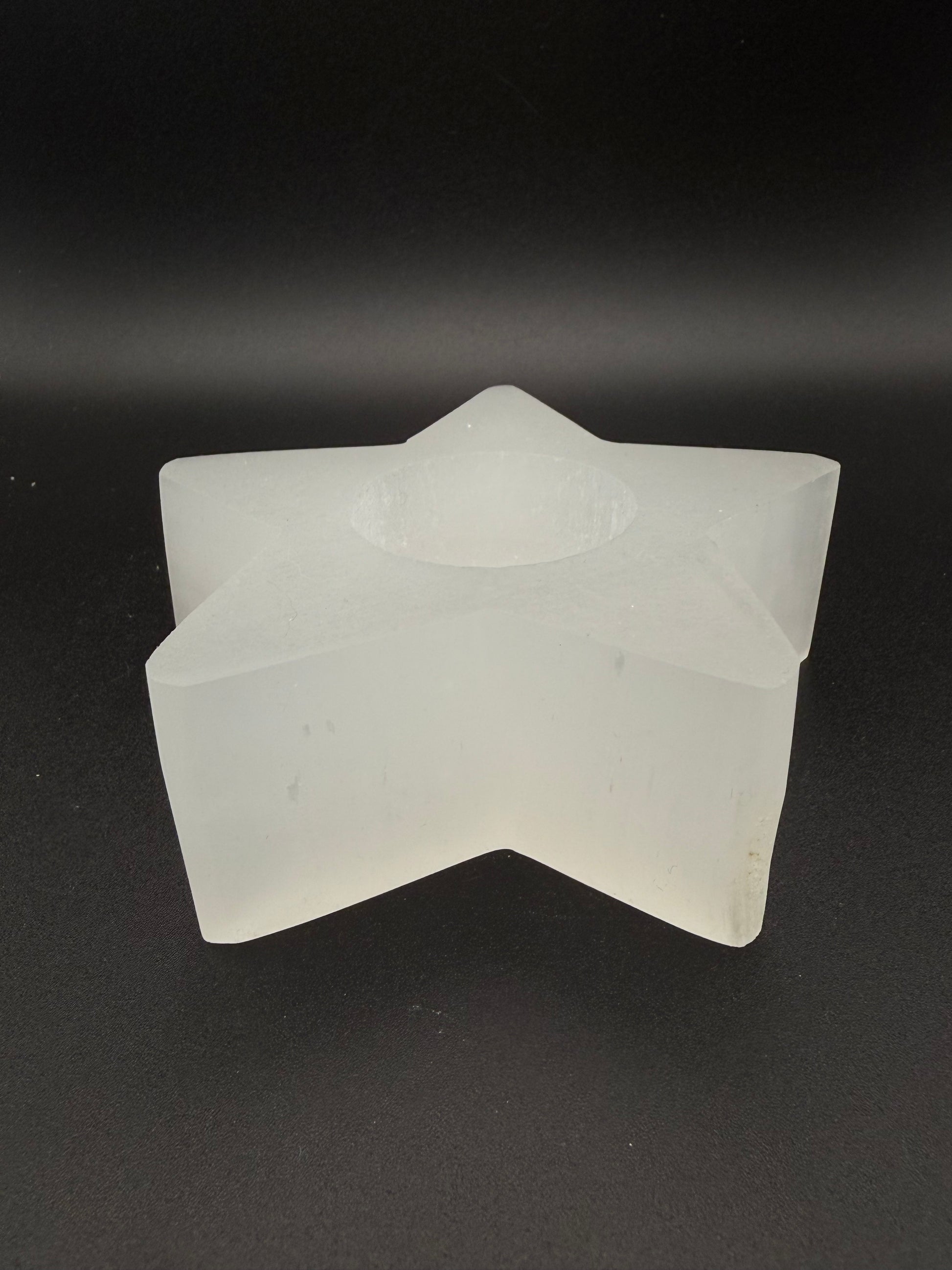 Star-shaped selenite candle holder.