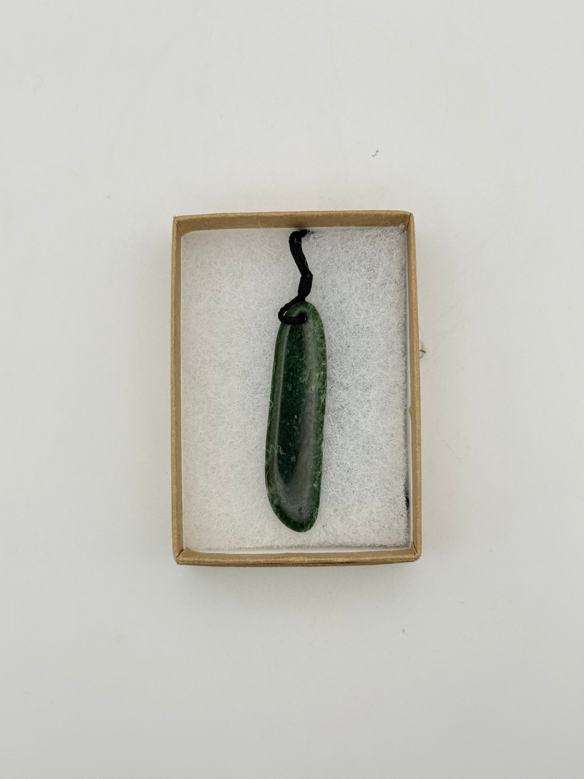 Green Jade pendant with string necklace.