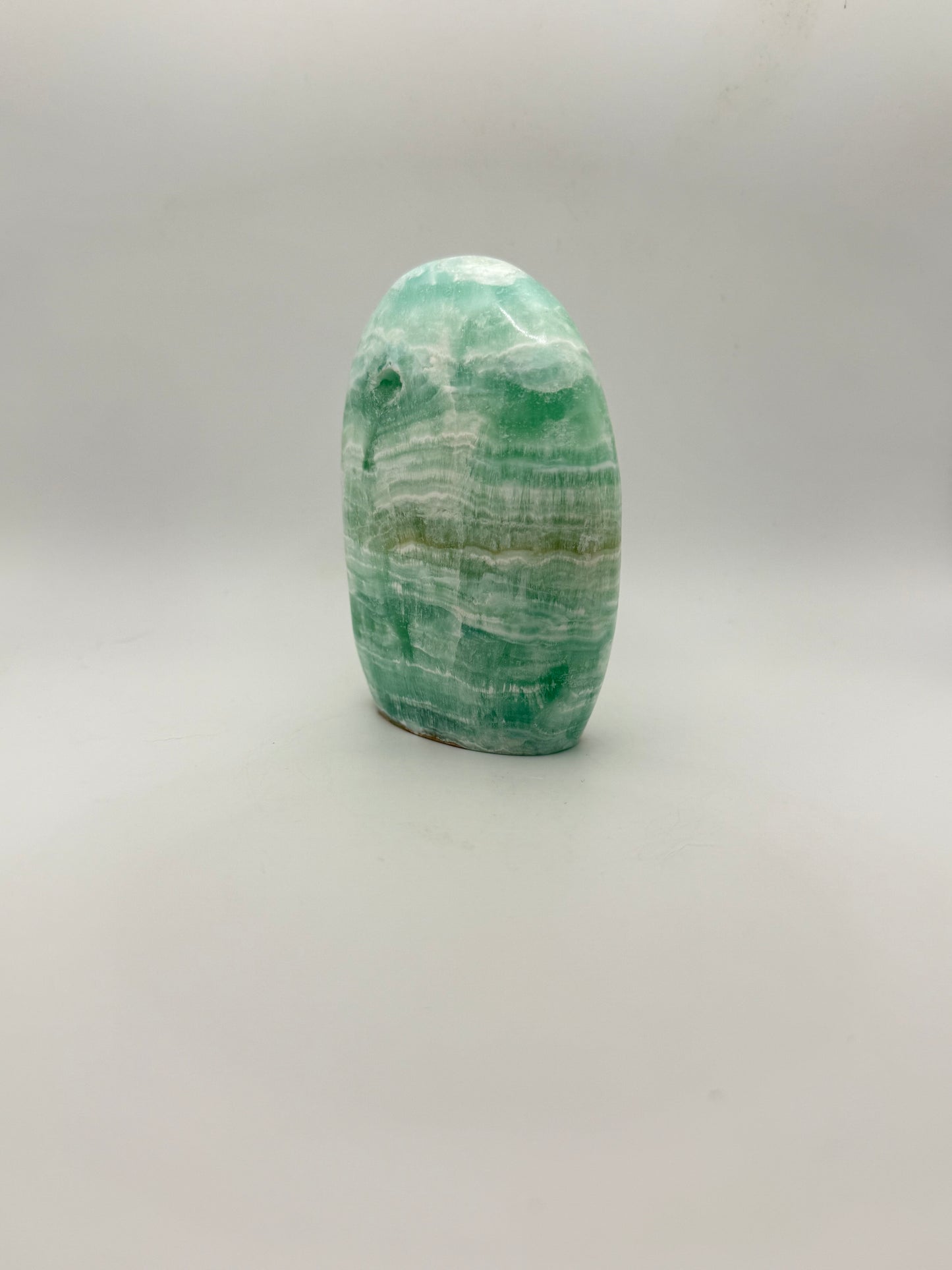 Caribbean calcite polished crystal free form in the shape of a dome.