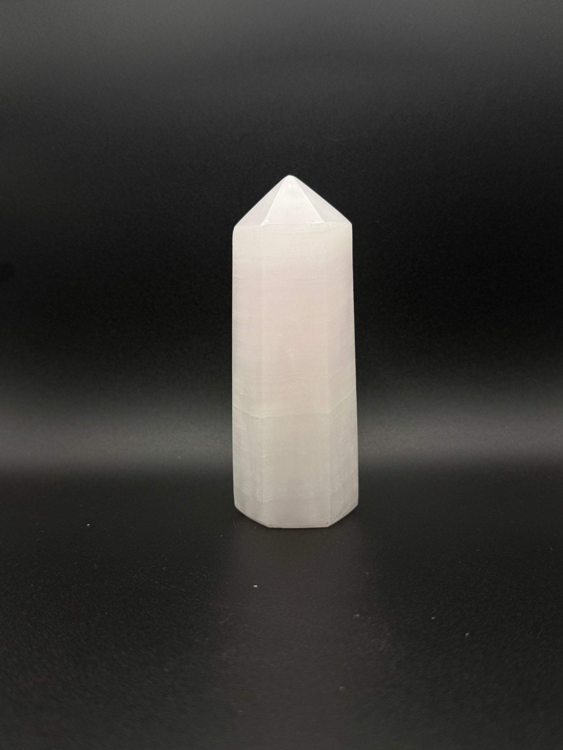 Polished pink calcite tower. Pink calcite glows under uv light.