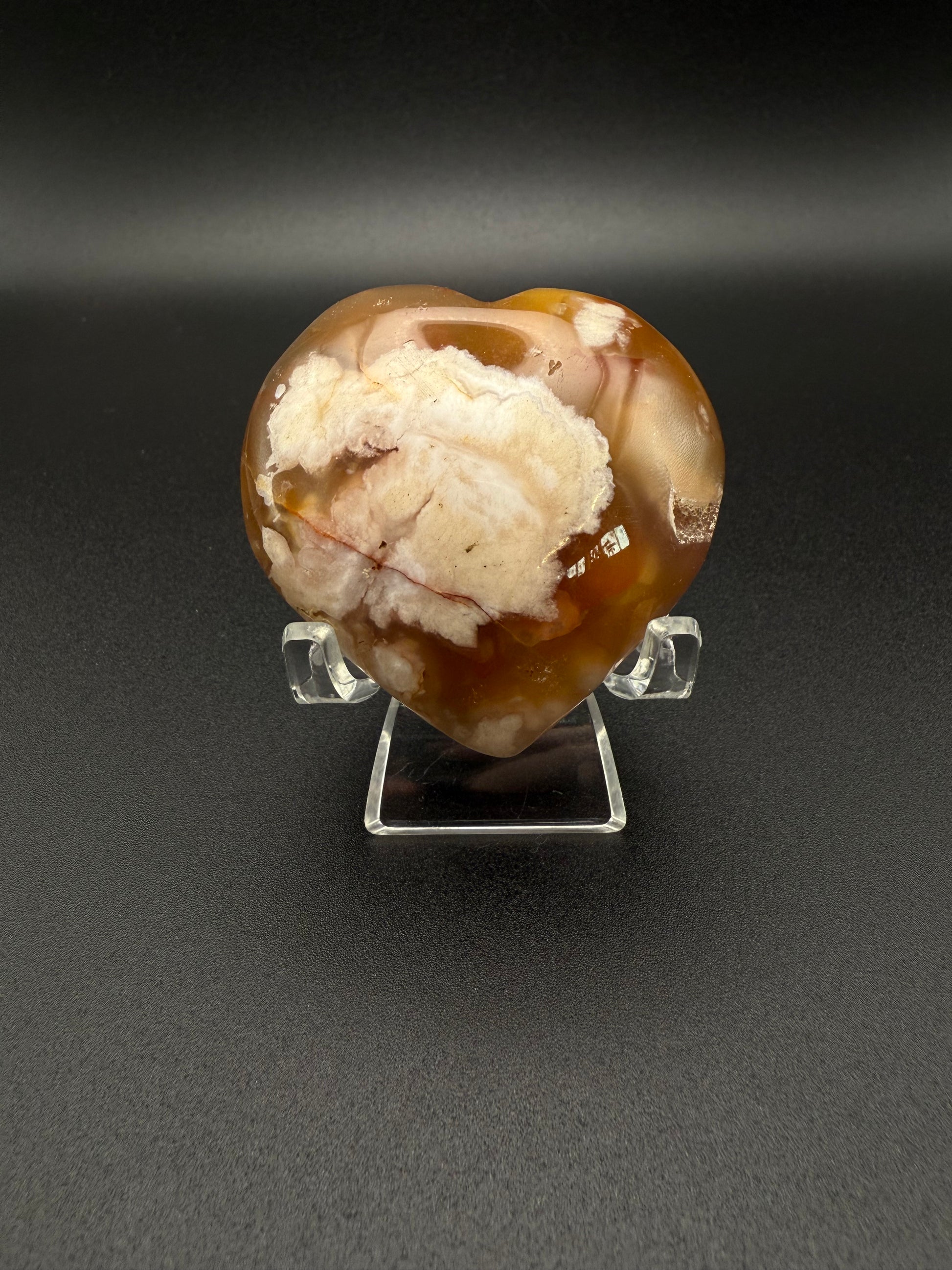 Flower Agate polished crystal in the shape of a heart.
