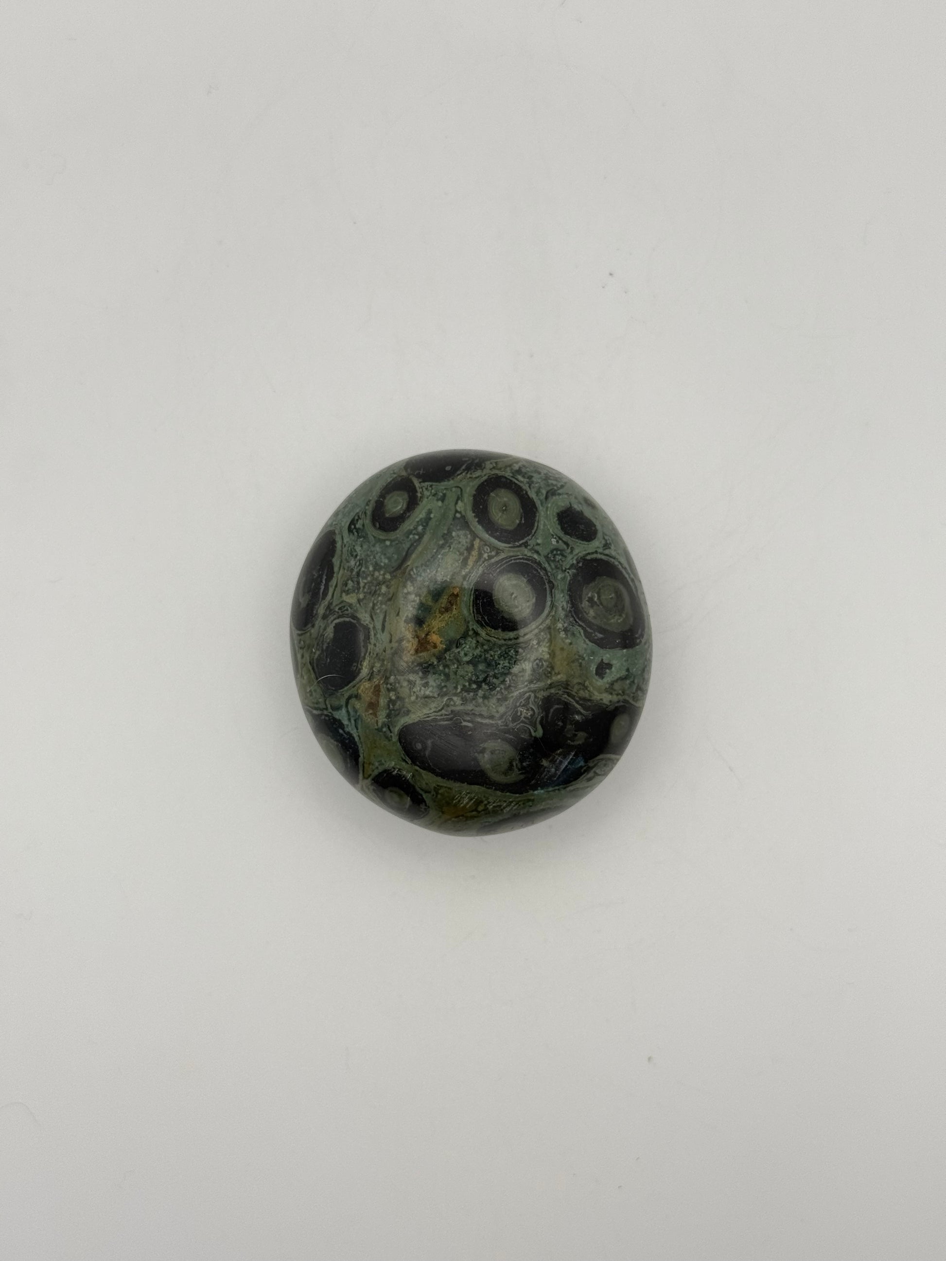 Polished kambaba jasper palm stone.