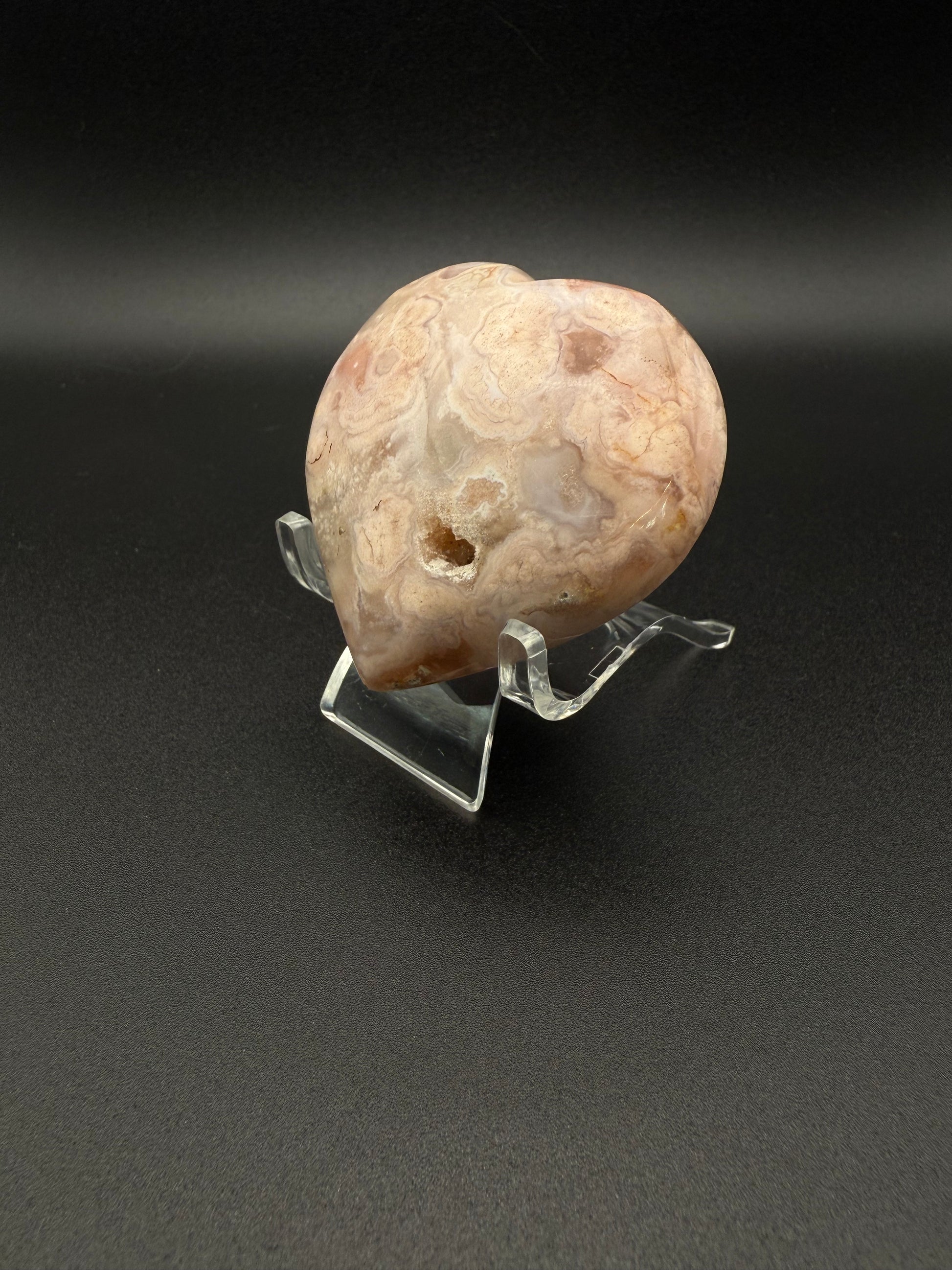 Flower agate polished crystal in the shape of a heart.