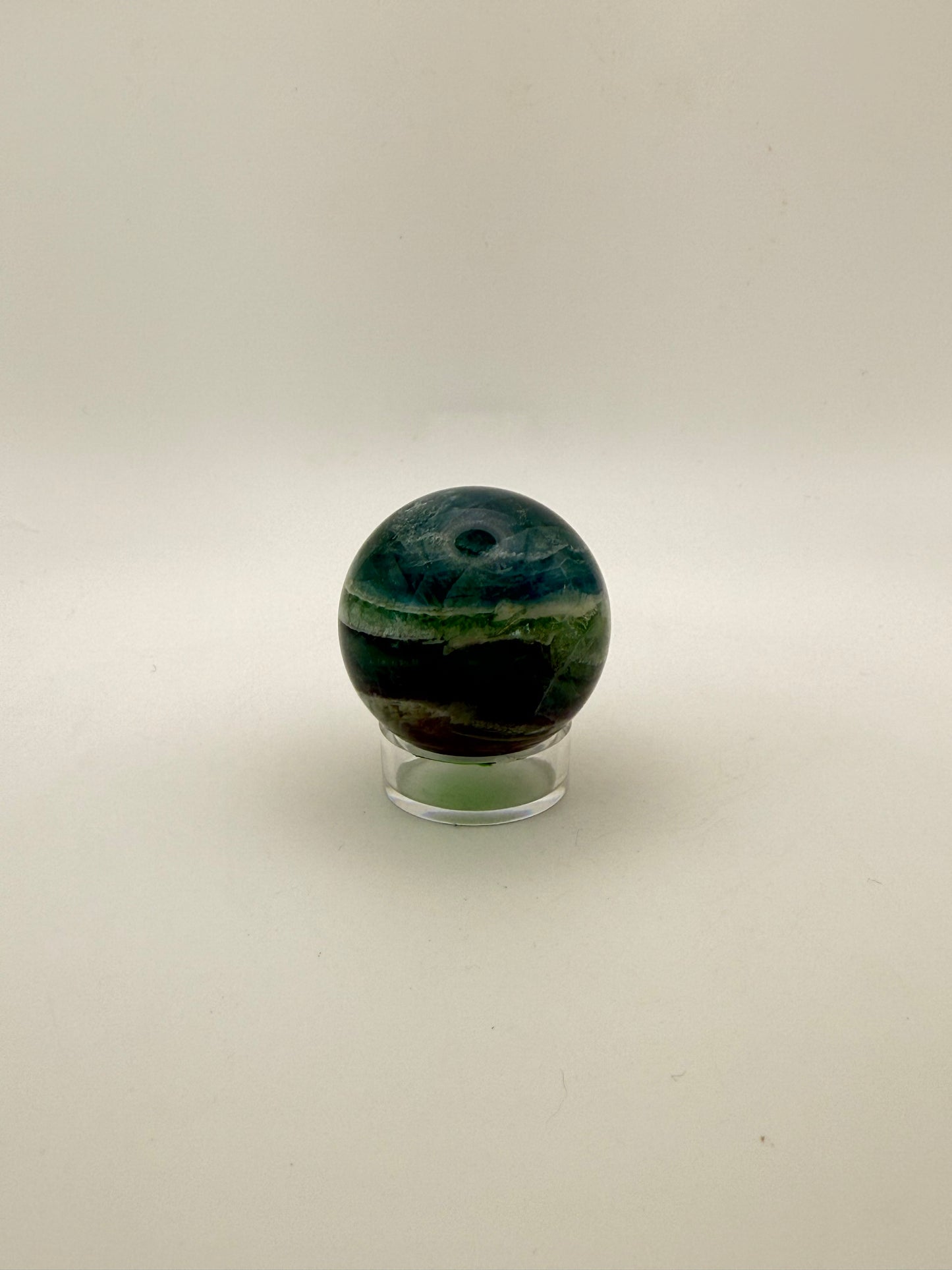 Rainbow Fluorite polished crystal sphere.