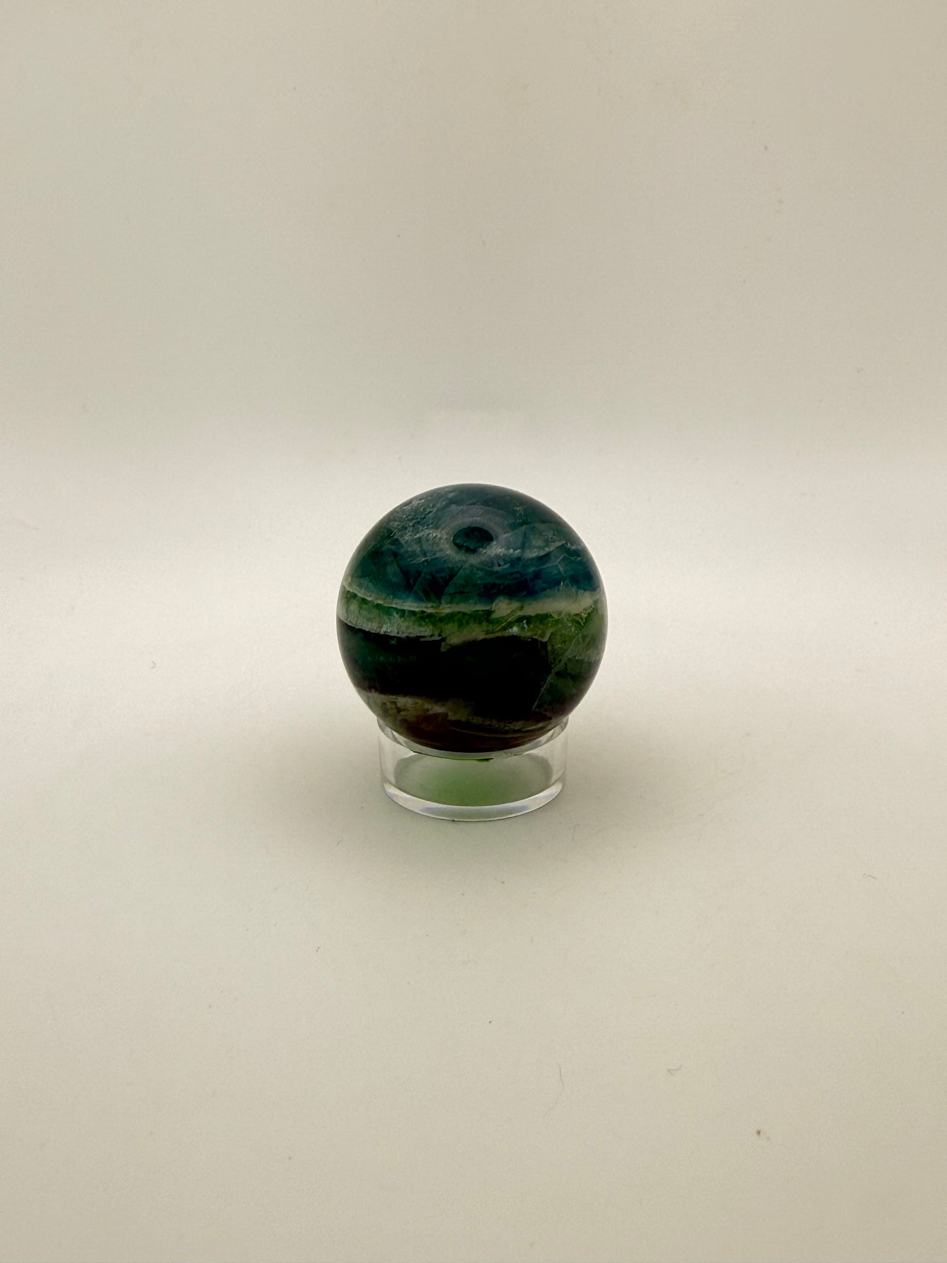 Rainbow Fluorite polished crystal sphere.