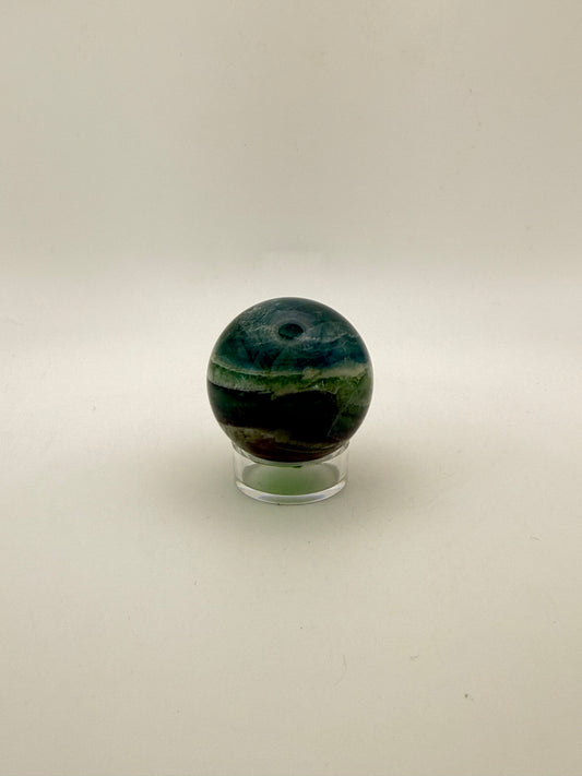 Rainbow Fluorite polished crystal sphere.