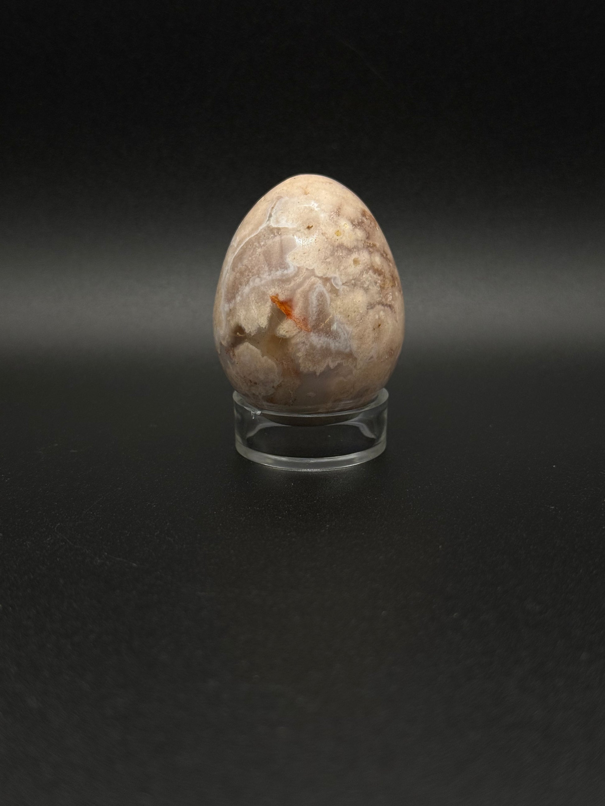 Polished flower agate crystal in the shape of an egg.