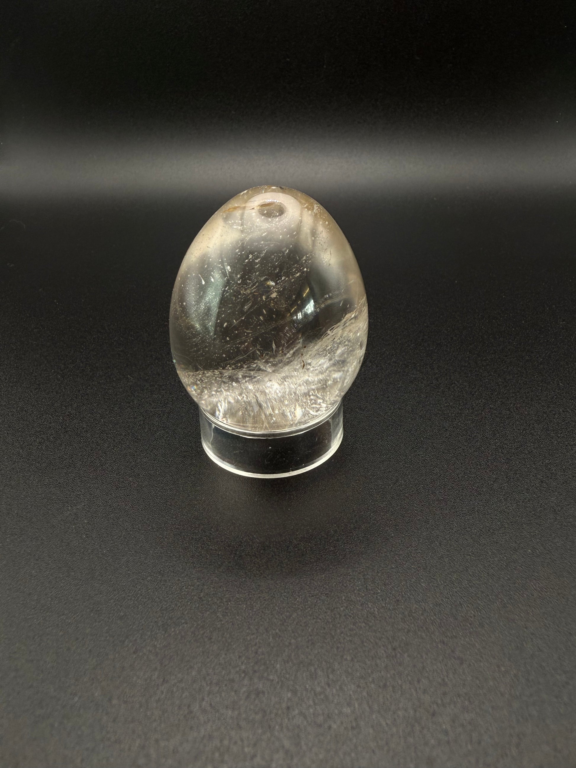 Clear quartz polished crystal thats egg shaped.