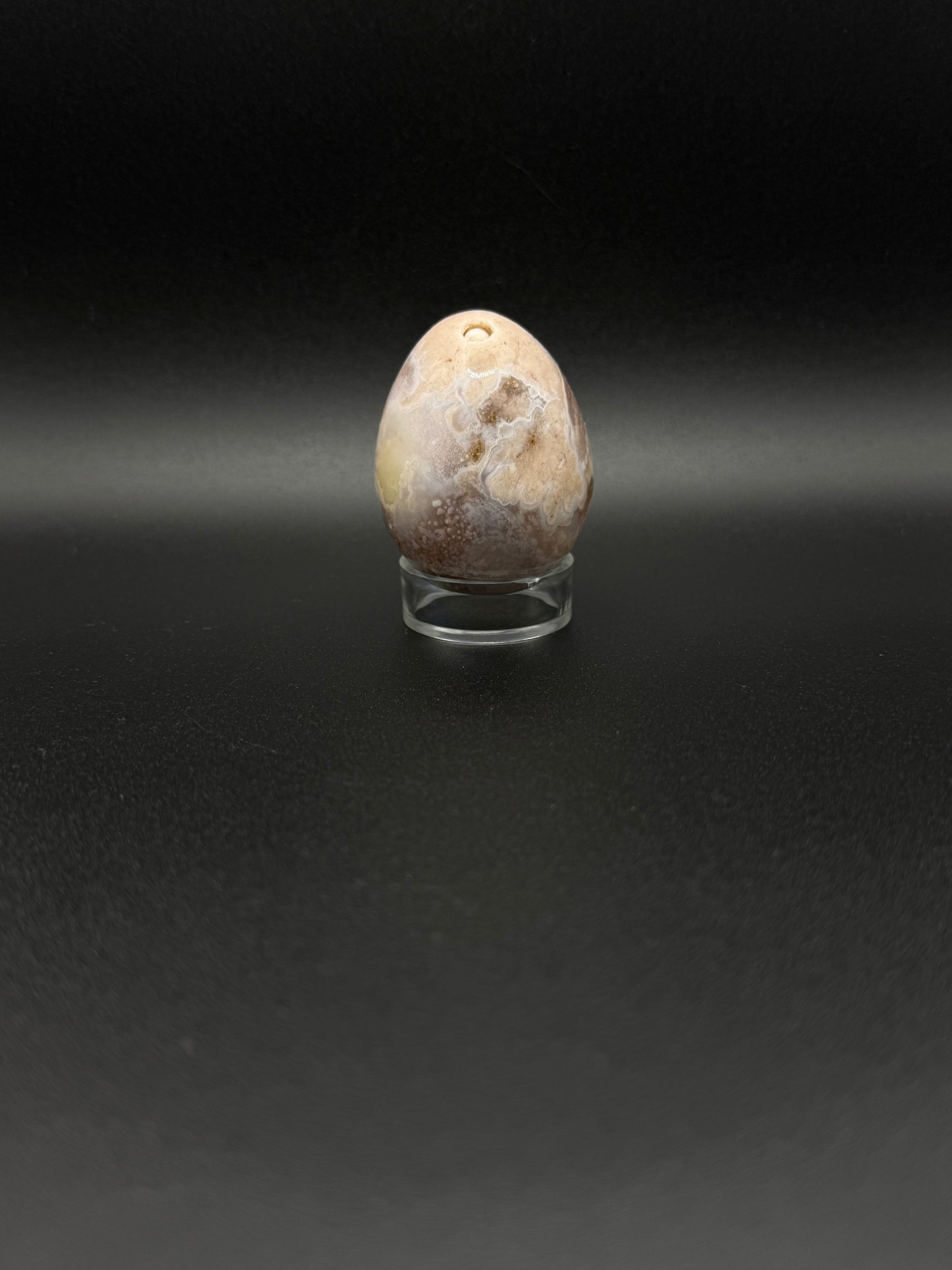Polished flower agate crystal in the shape of an egg.