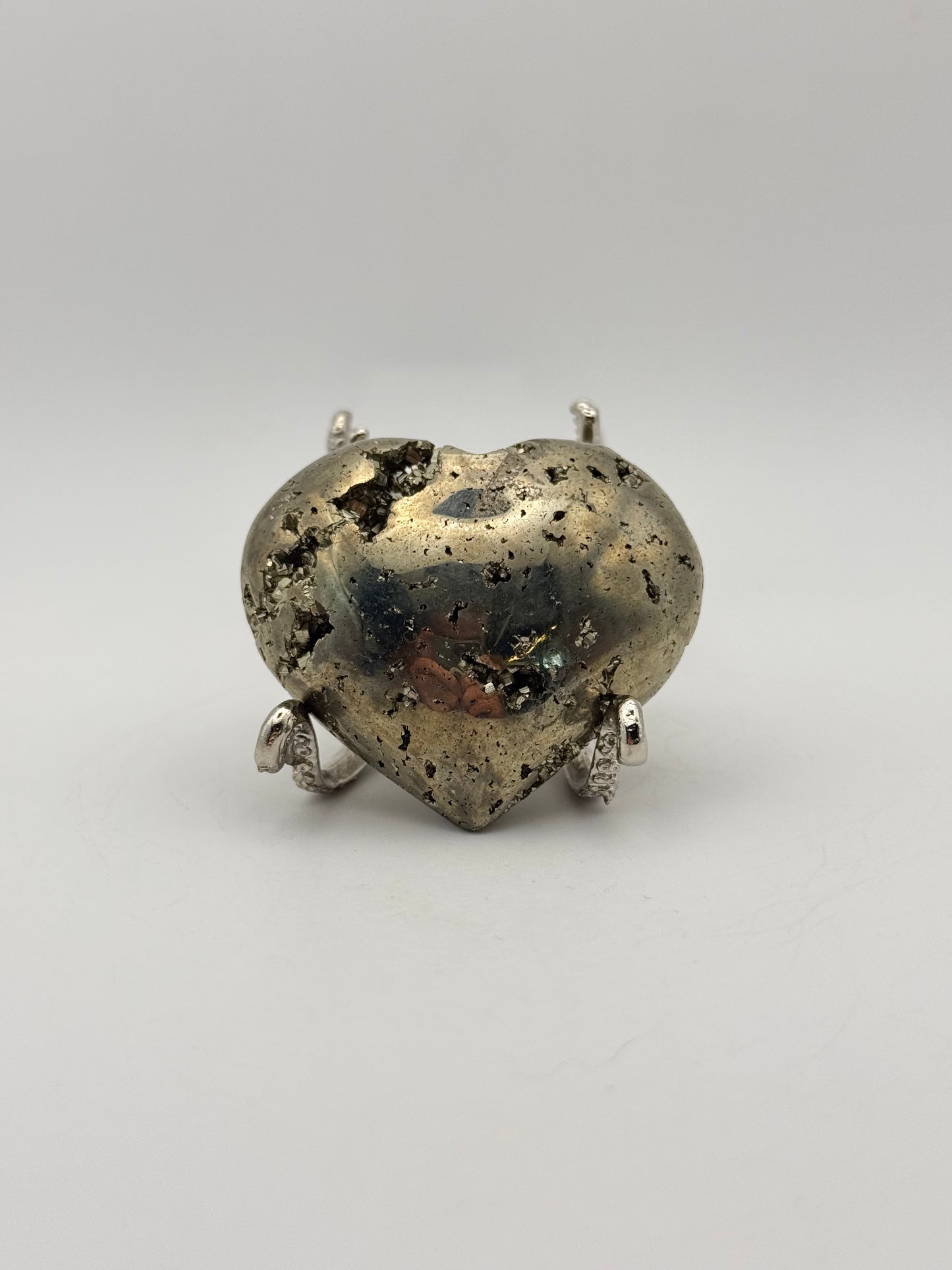 Polished pyrite crystal in the shape of a heart.