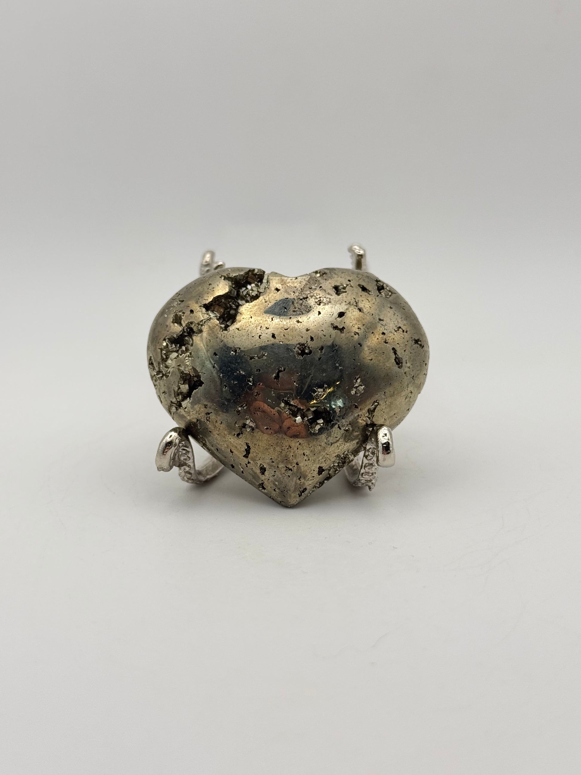 Polished pyrite crystal in the shape of a heart.