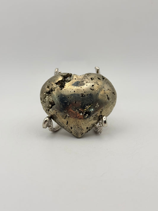 Polished pyrite crystal in the shape of a heart.
