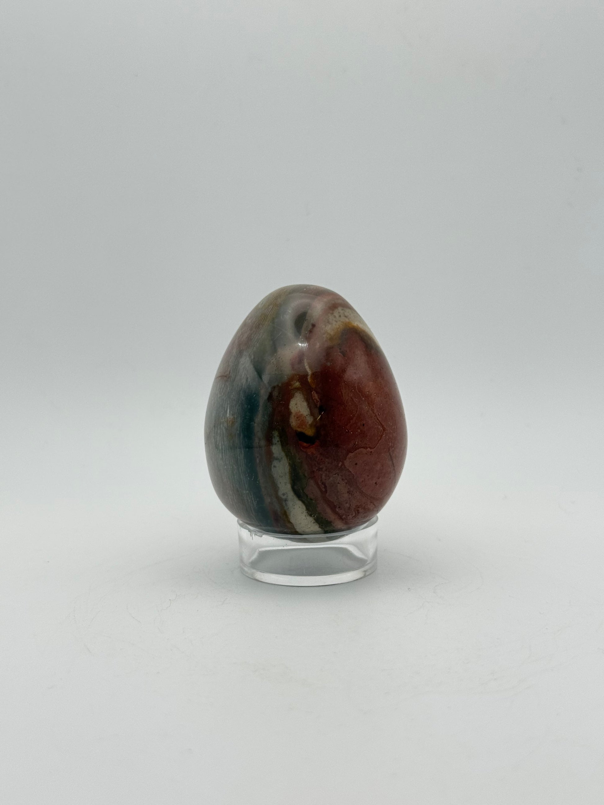 Polished polychrome jasper shaped into an egg.