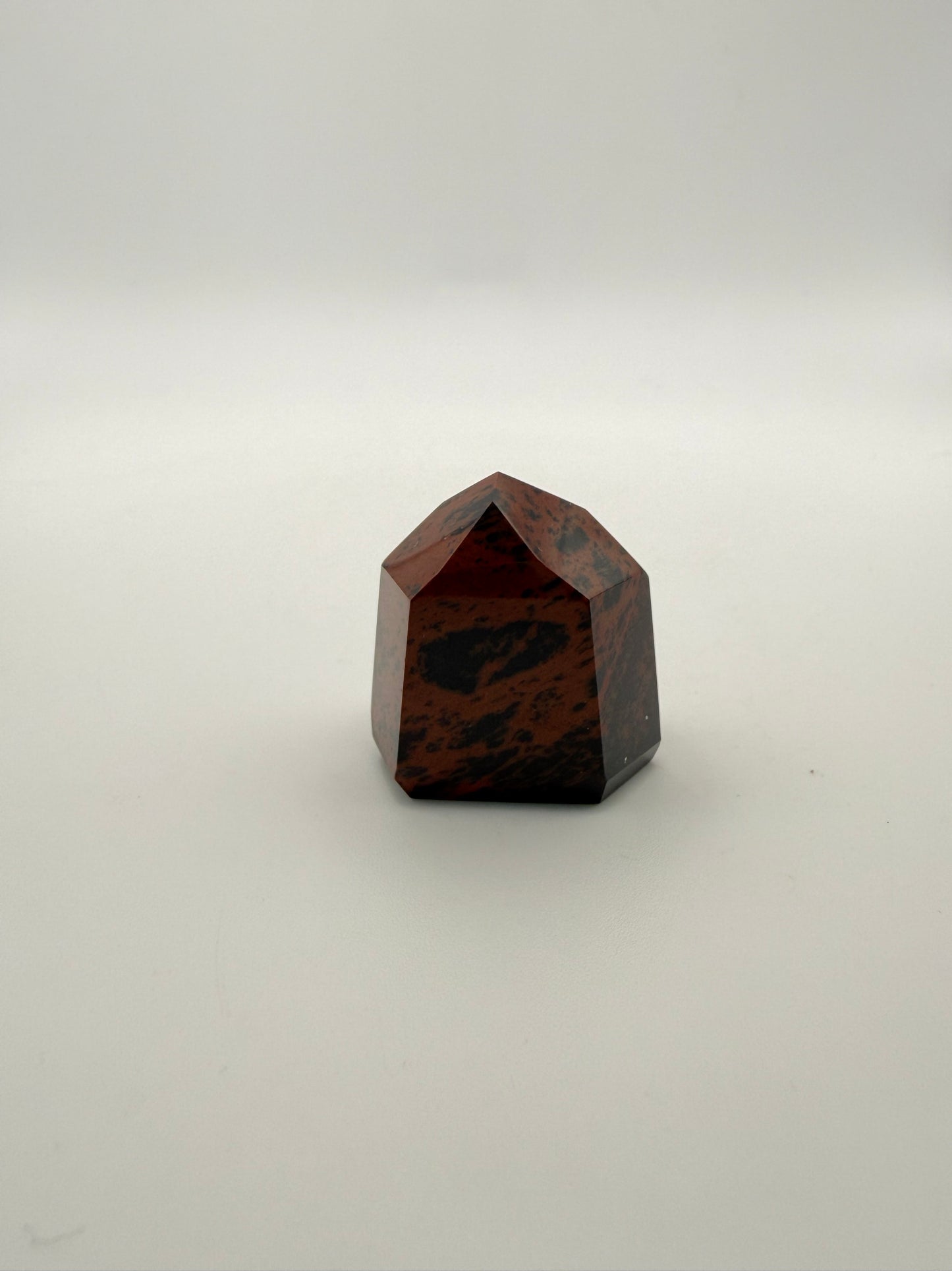 Polished mahogany obsidian tower with six sides.