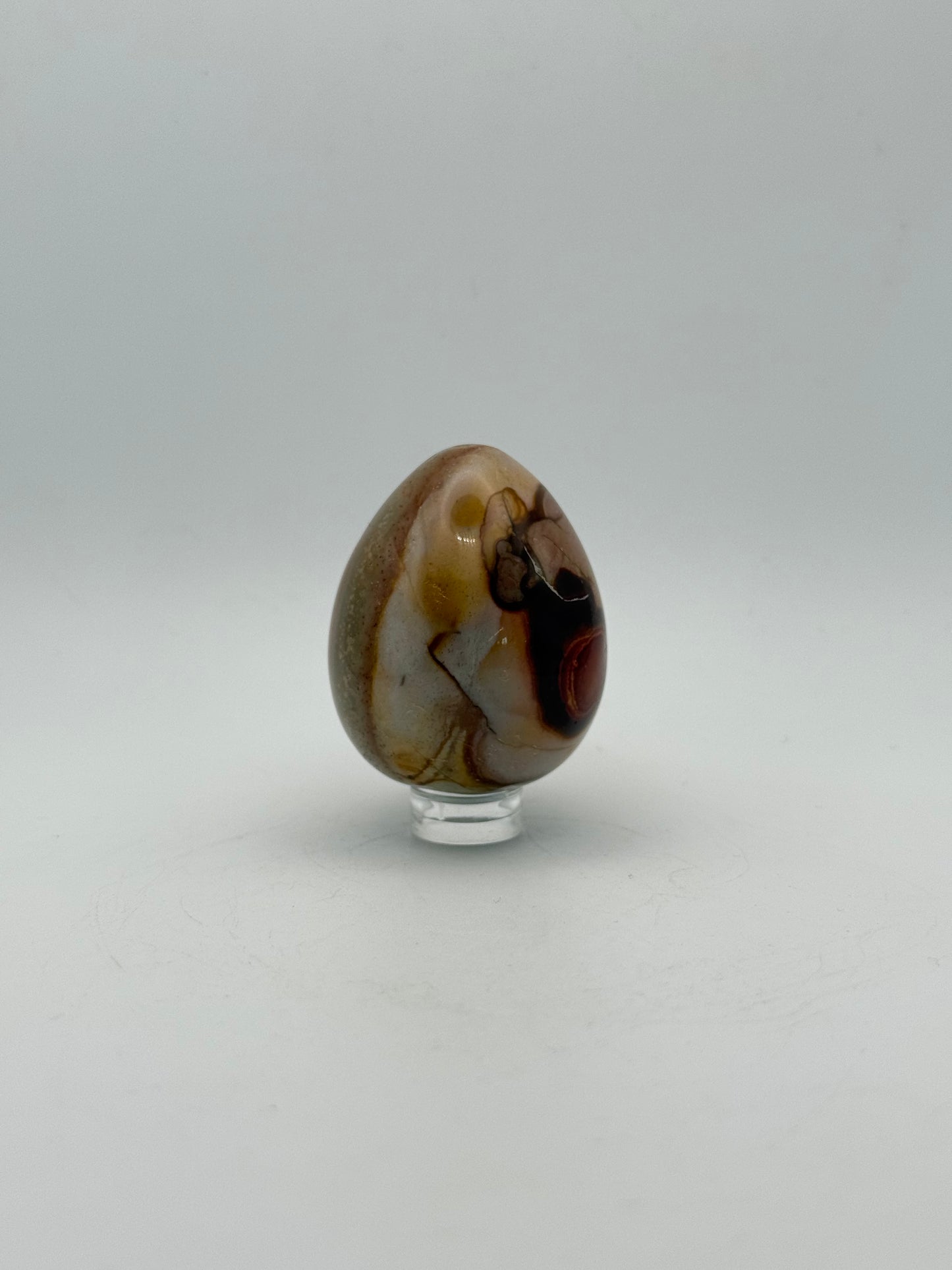 Polished polychrome jasper shaped into an egg.