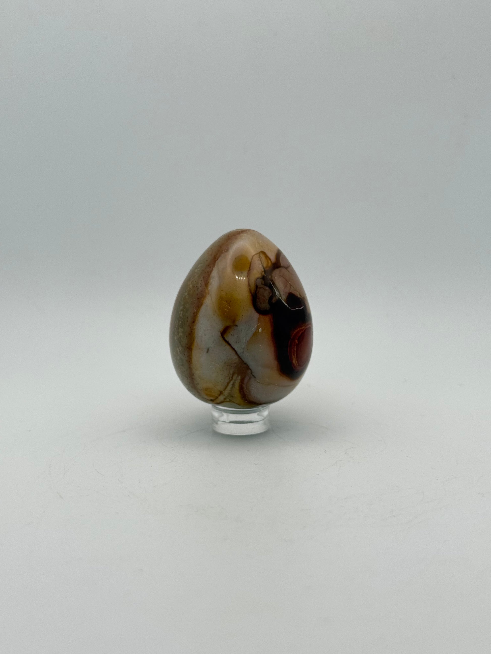 Polished polychrome jasper shaped into an egg.