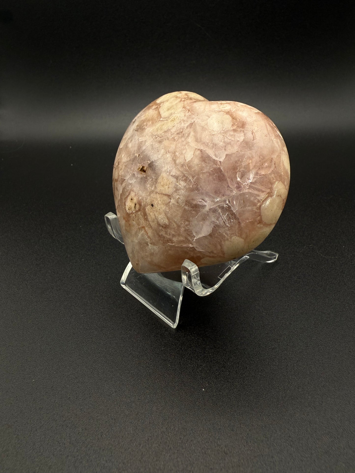 Flower agate polished crystal in the shape of a heart.