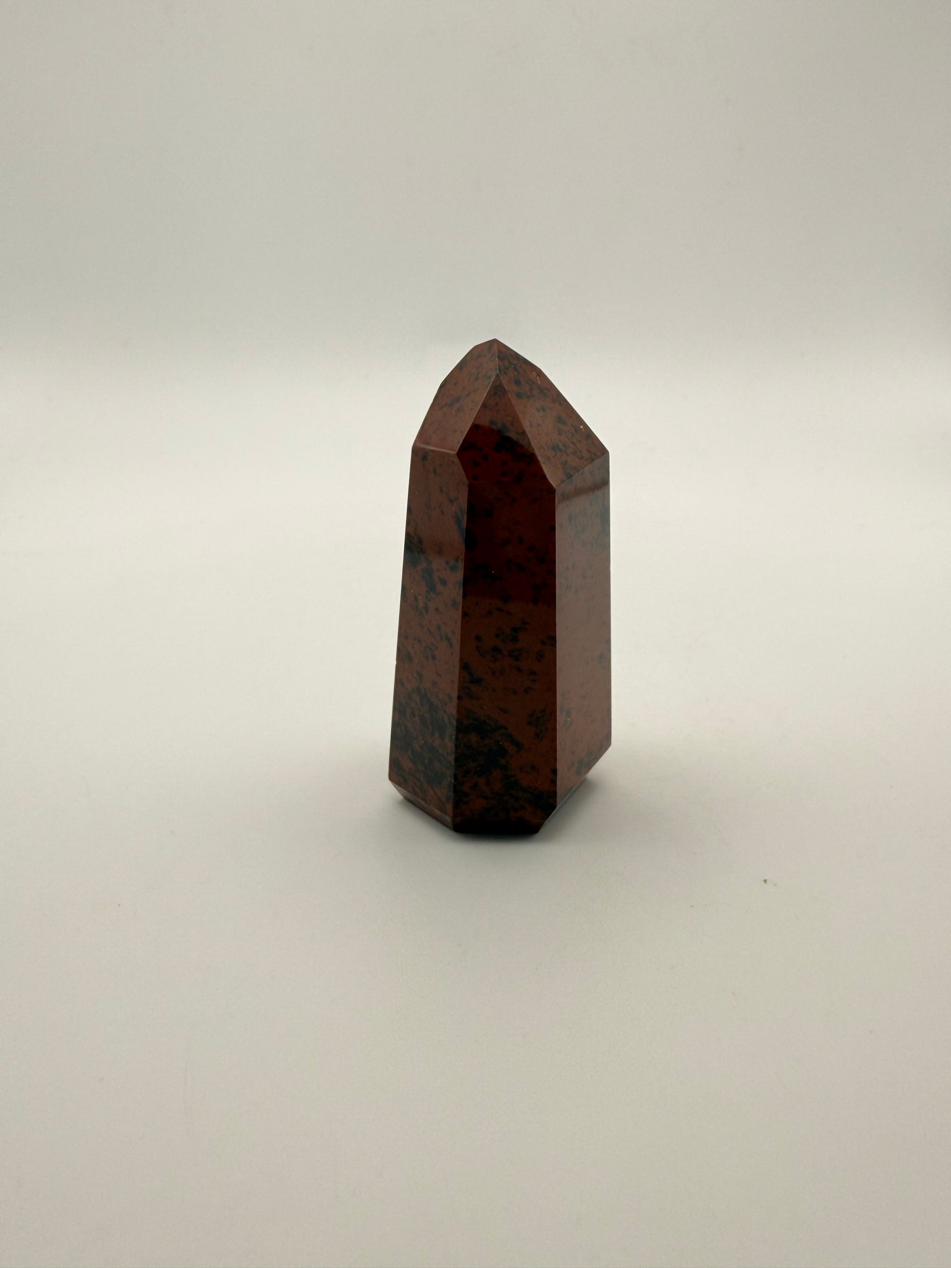 Polished mahogany obsidian tower with six sides.