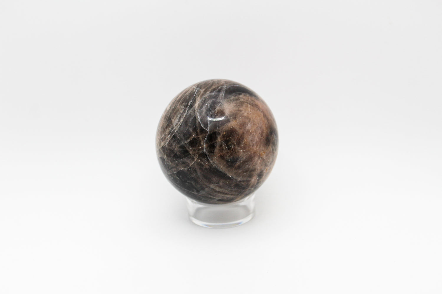 A polished black moonstone sphere.