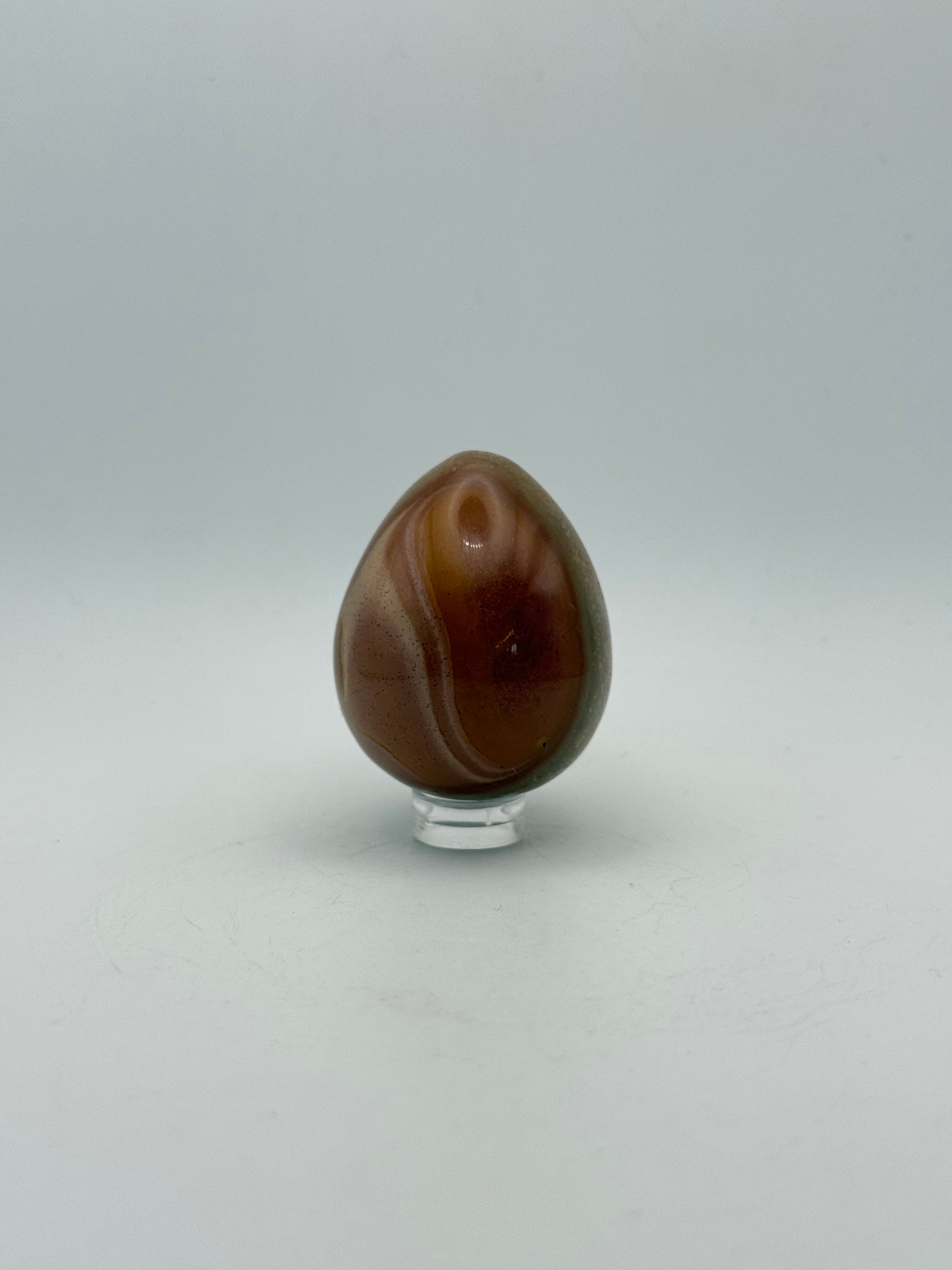 Polished polychrome jasper shaped into an egg.