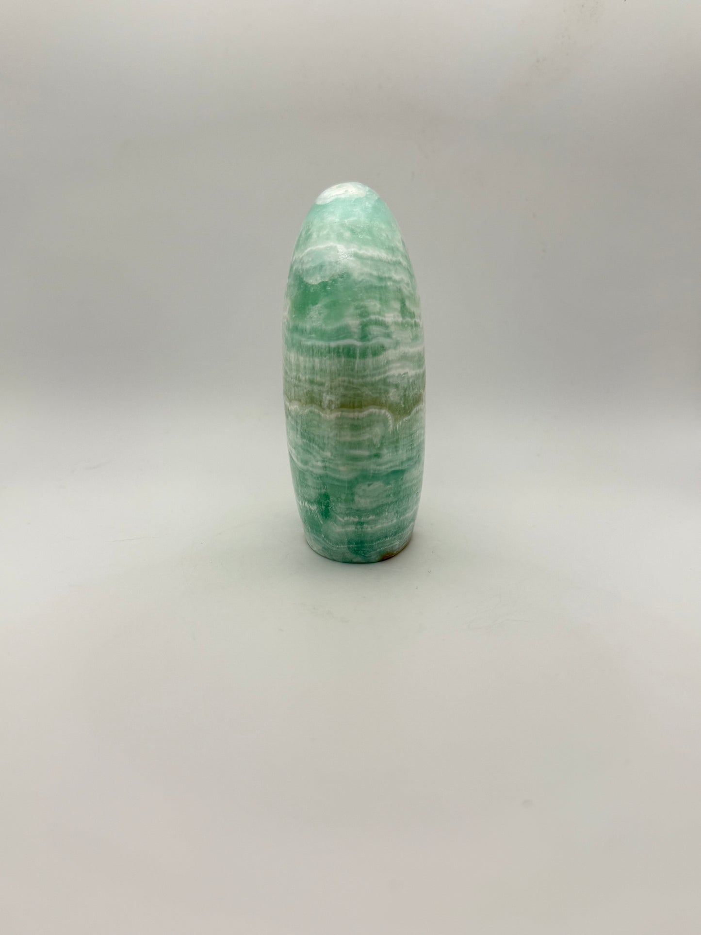 Caribbean calcite polished crystal free form in the shape of a dome.