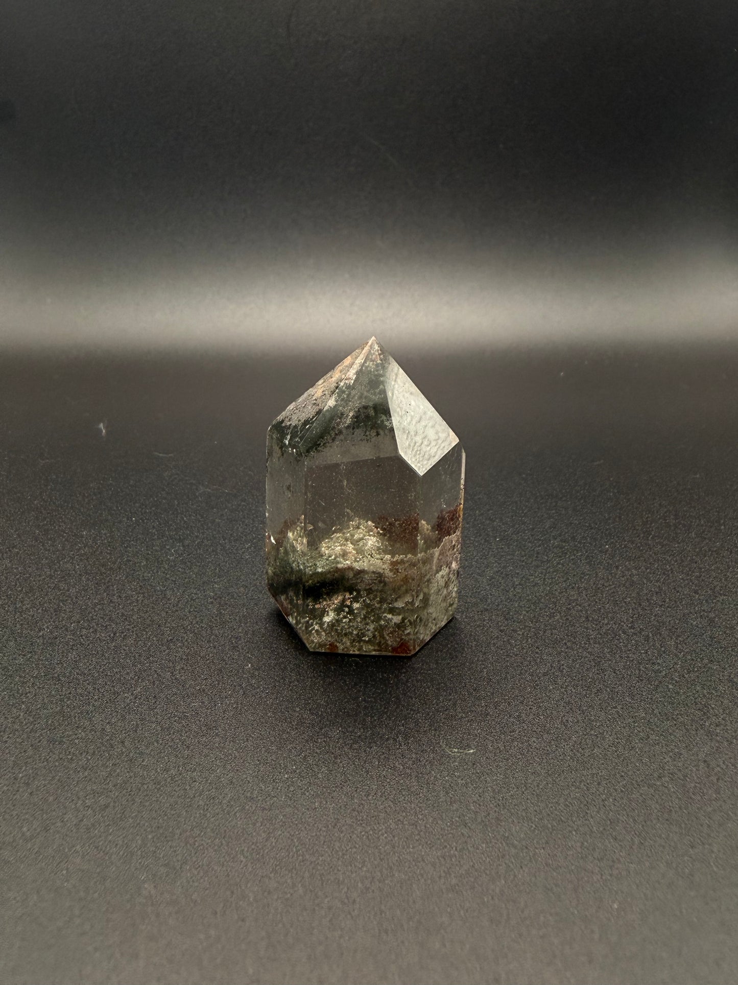 Polished garden quartz crystal tower with six sides.