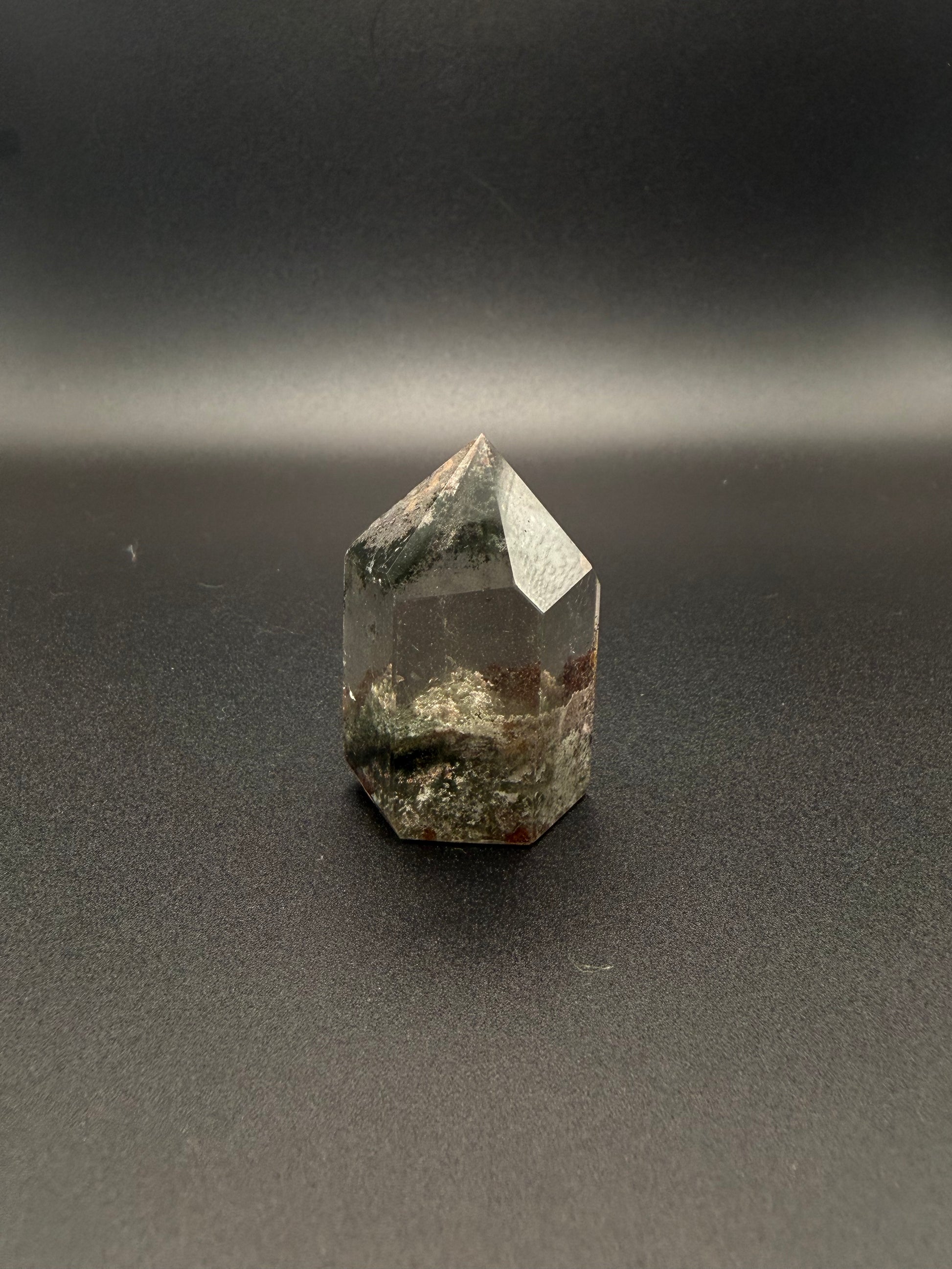 Polished garden quartz crystal tower with six sides.