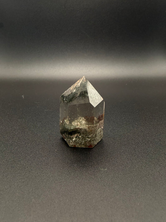 Polished garden quartz crystal tower with six sides.