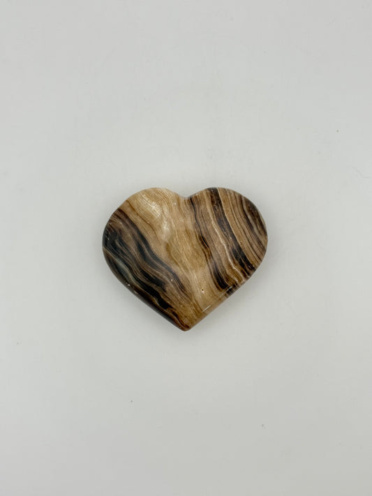 Polished chocolate calcite heart shaped crystal.