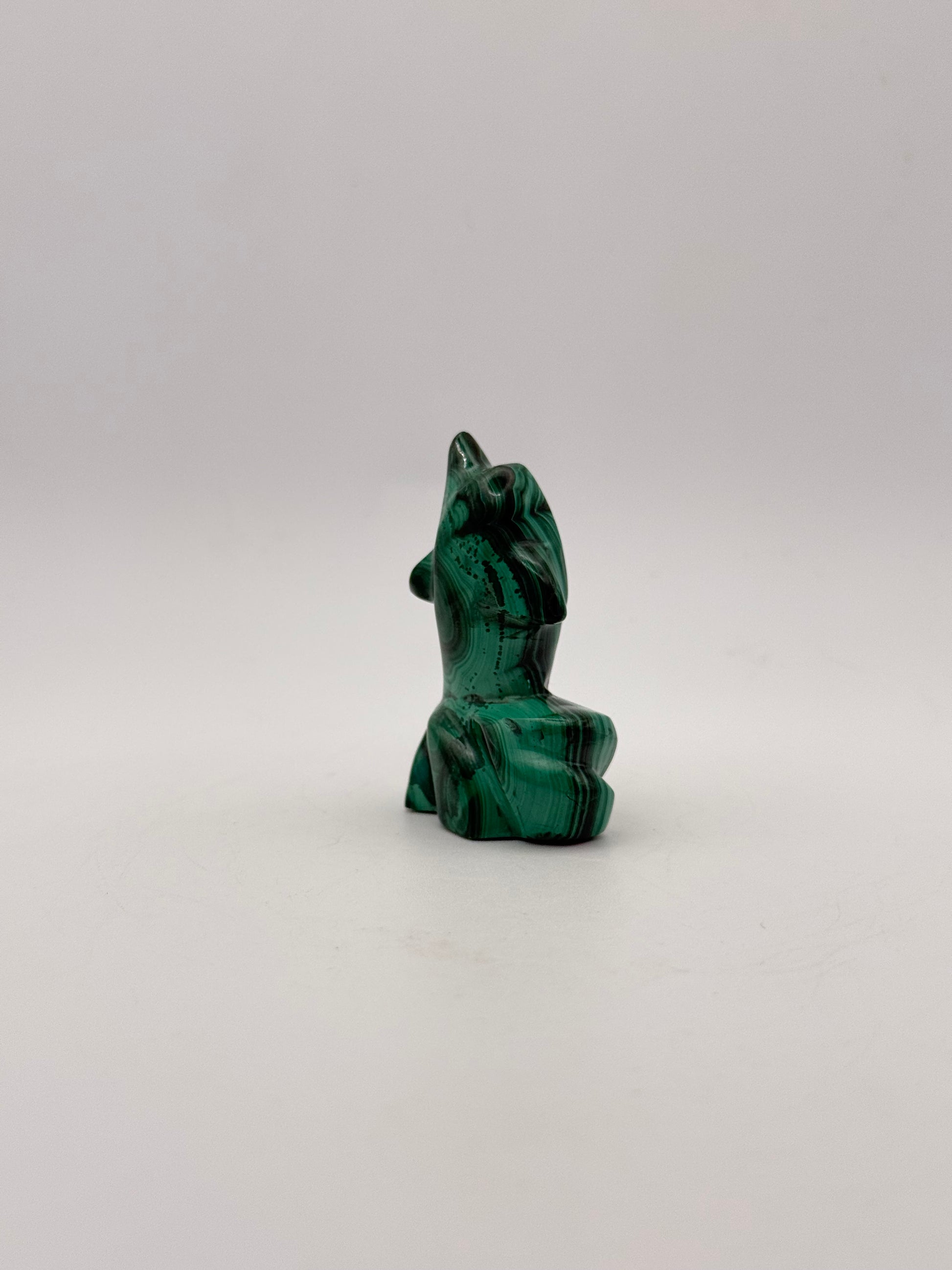 Polished malachite dolphin carving.