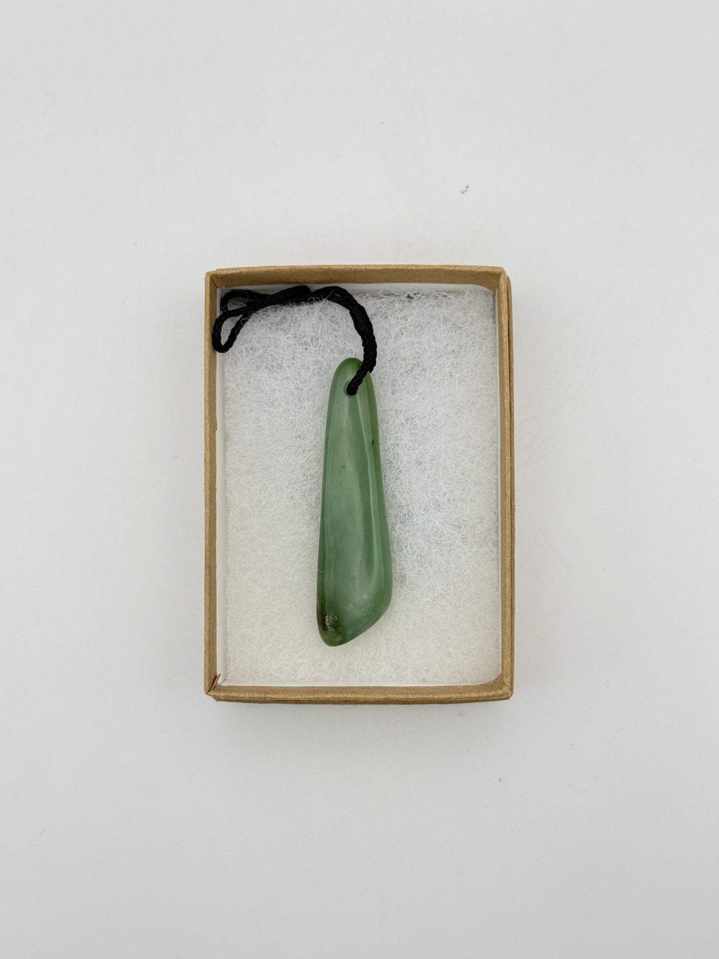 Green Jade pendant with string necklace.