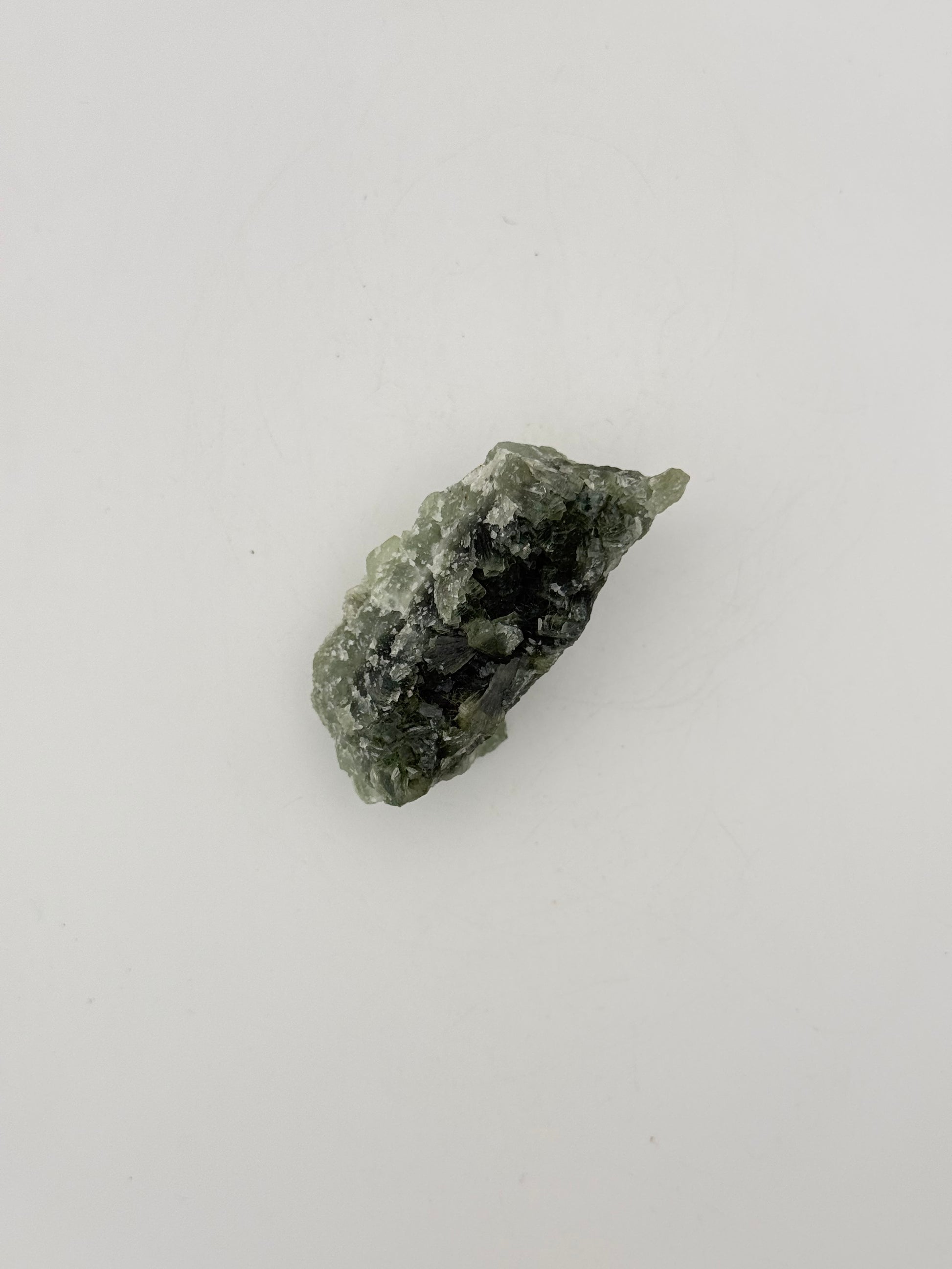 Raw Prehnite specimen with amazing green color.