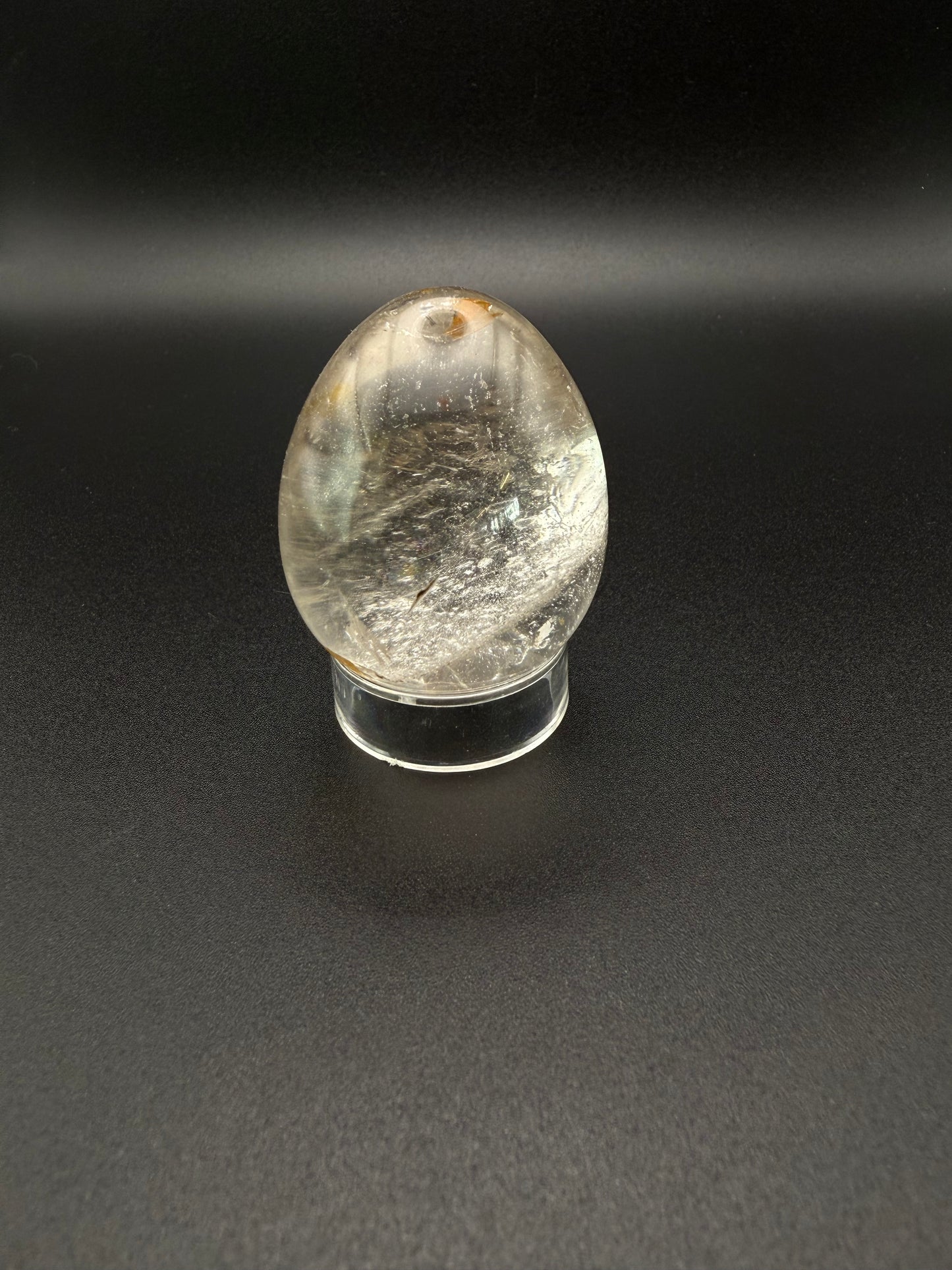 Clear quartz polished crystal thats egg shaped.