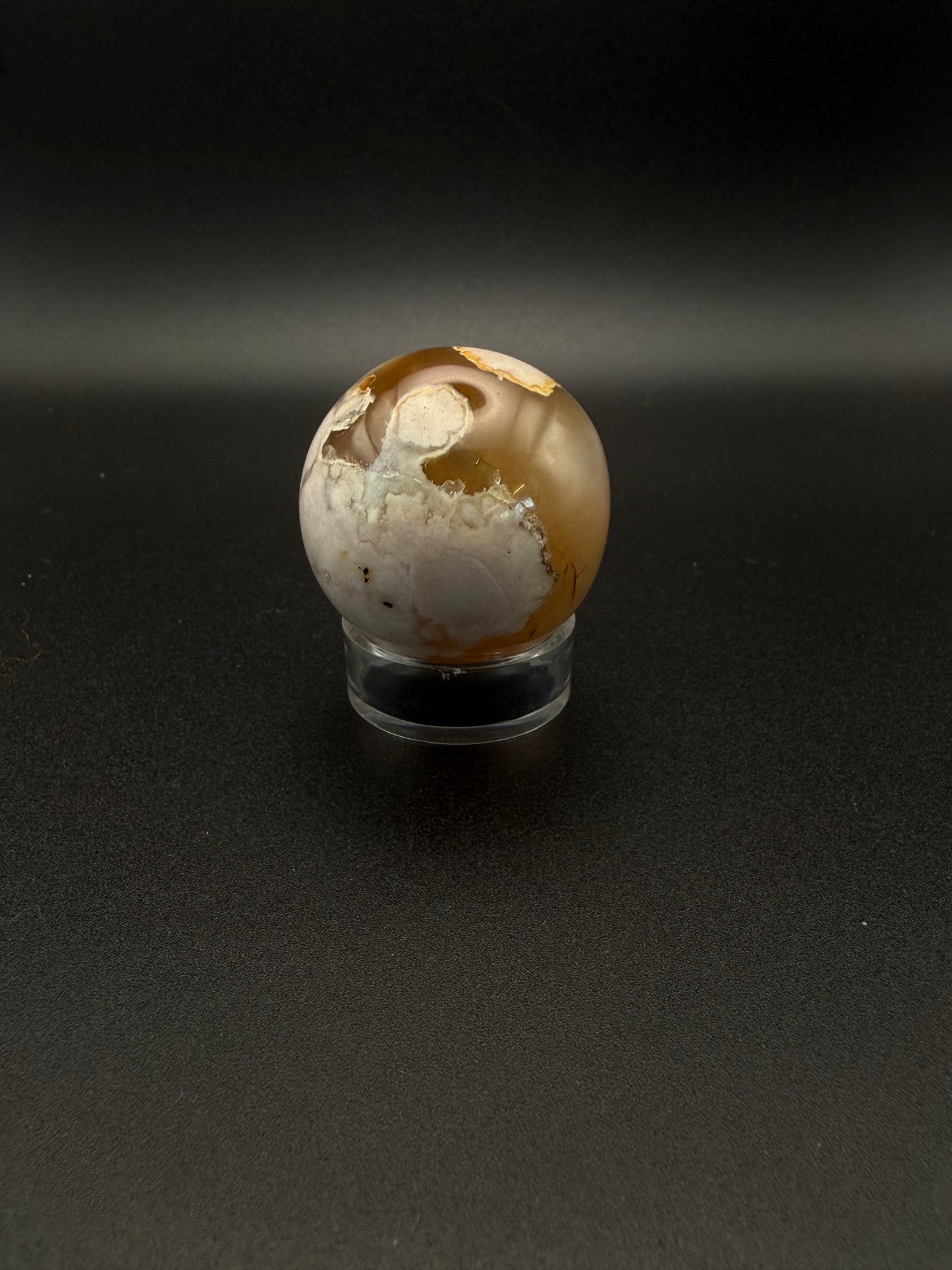 Flower agate polished crystal in the shape of a sphere.