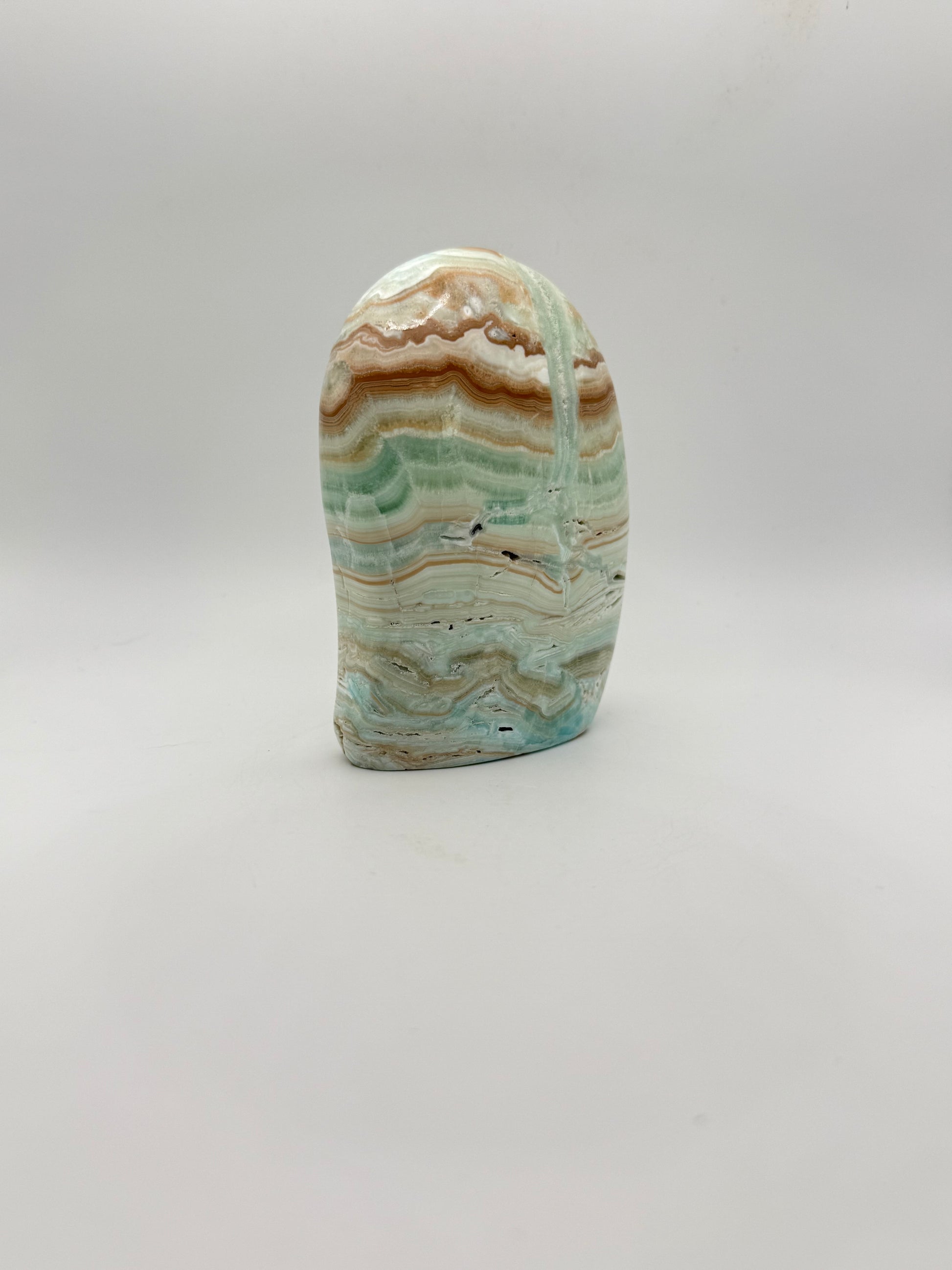 Caribbean calcite polished crystal free form in the shape of a dome.