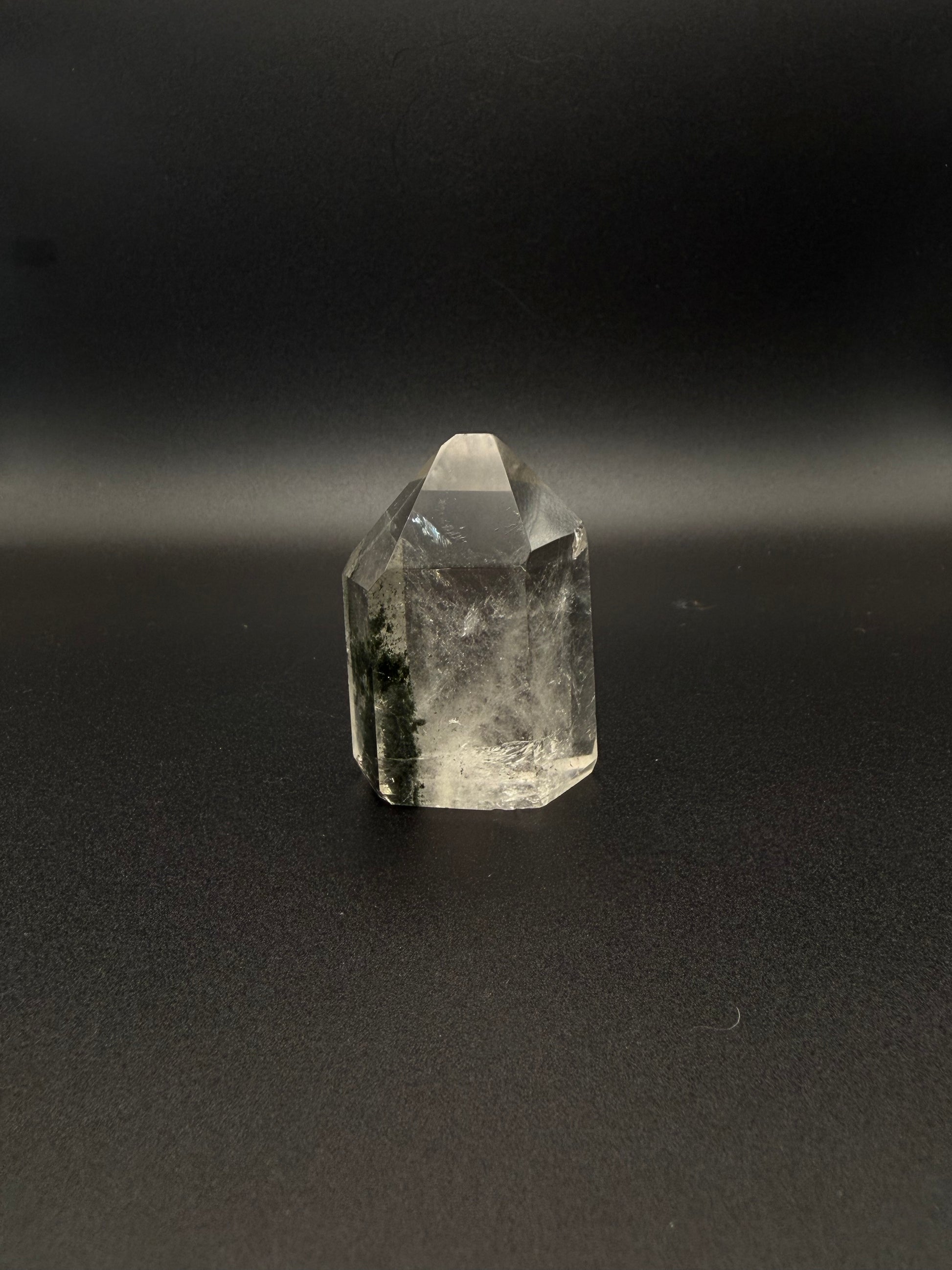 Polished garden quartz crystal tower with six sides.