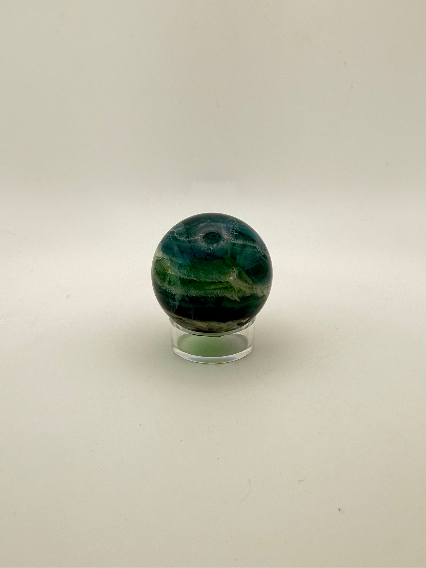 Rainbow Fluorite polished crystal sphere.