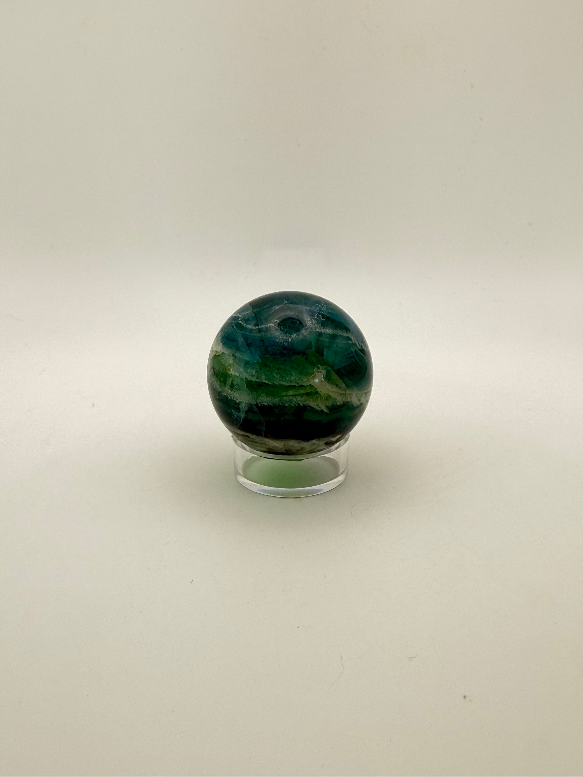 Rainbow Fluorite polished crystal sphere.