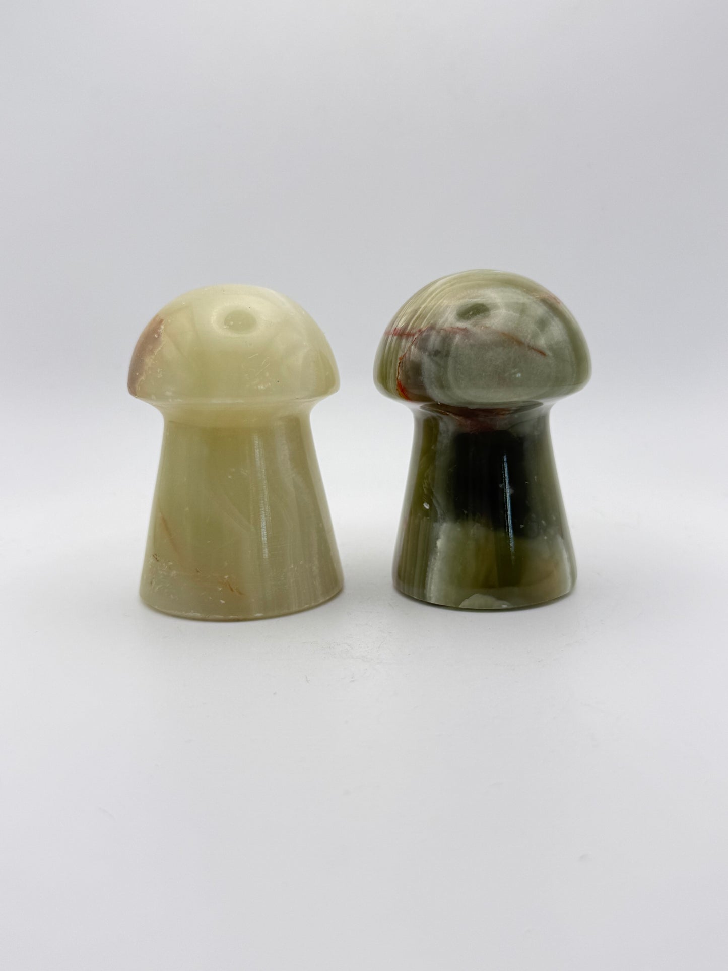 Two onyx mushroom-shaped stones.