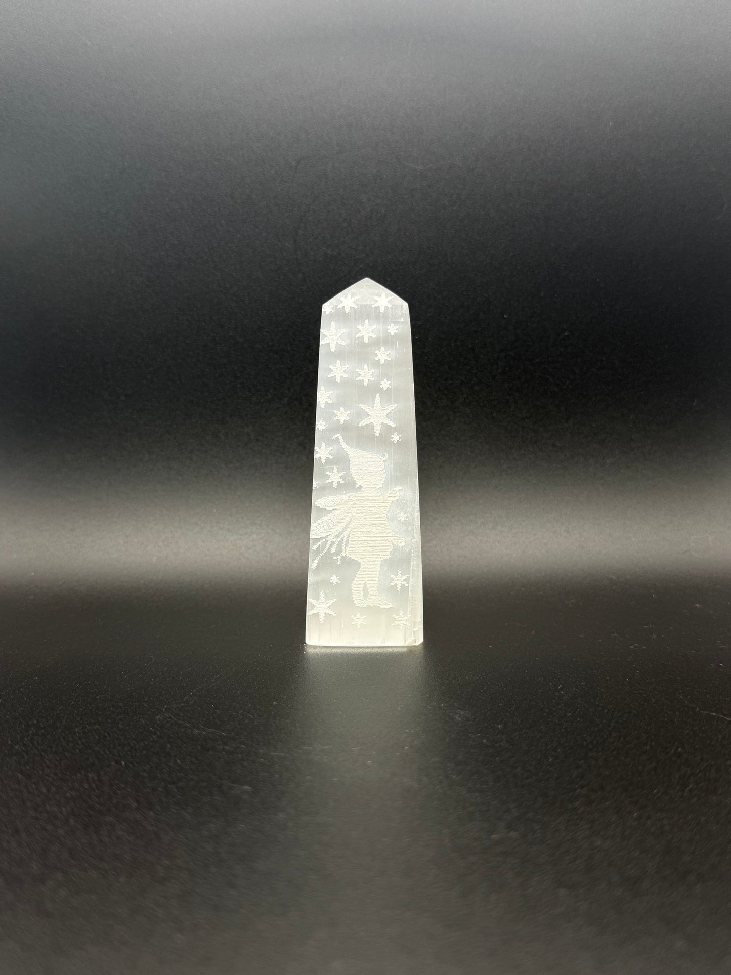 Selenite tower with engraved image of a fairy and stars.