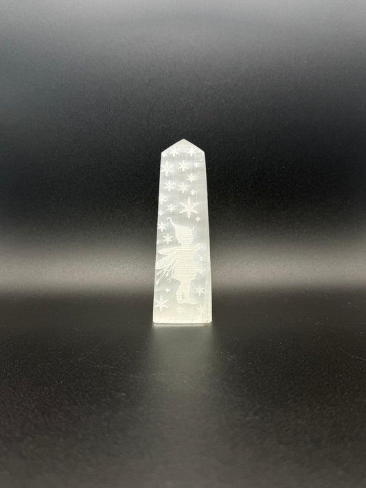 Selenite tower with engraved image of a fairy and stars.