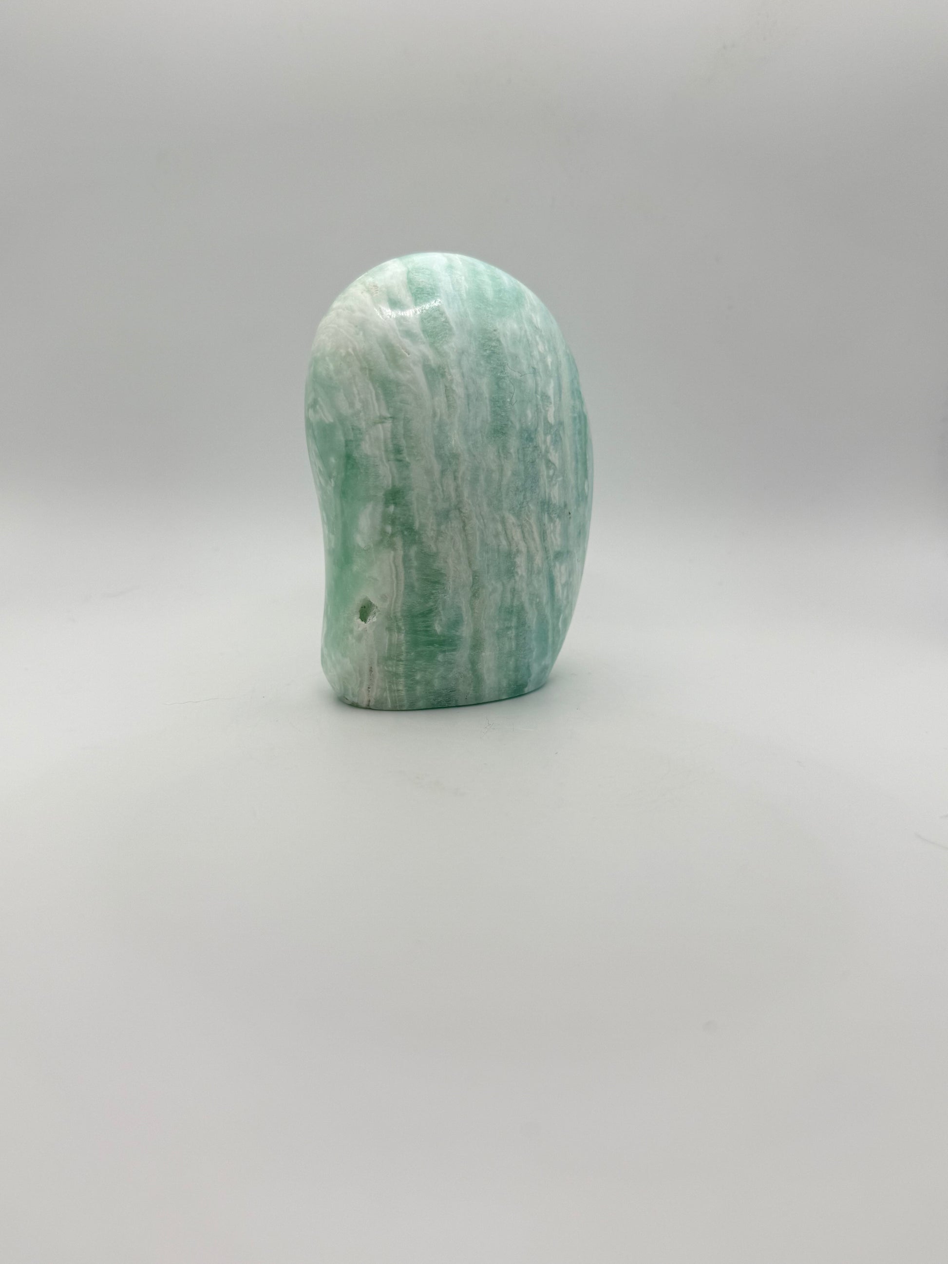 Caribbean calcite polished crystal free form in the shape of a dome.