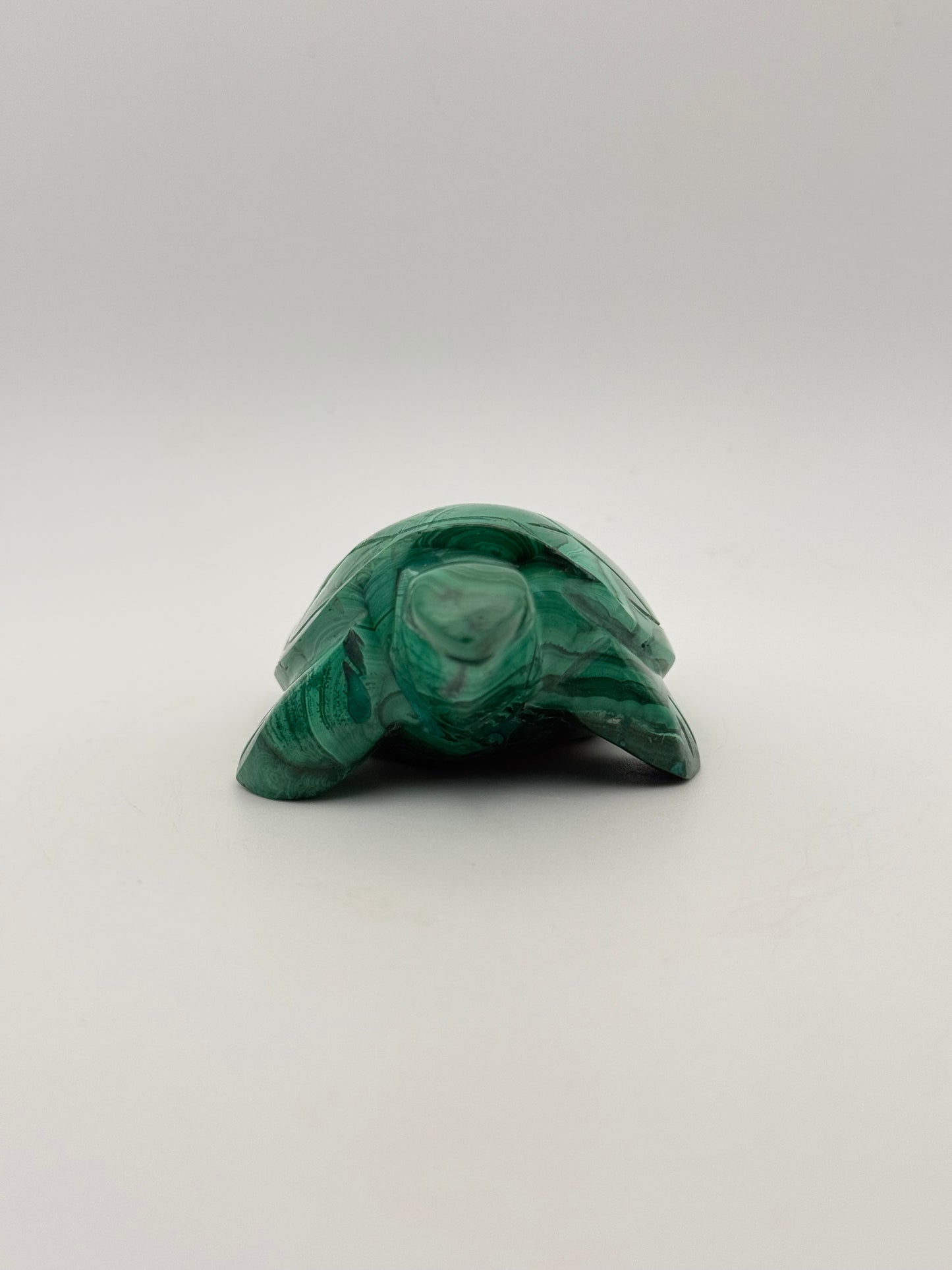Vibrant green malachite stone carving of a turtle.