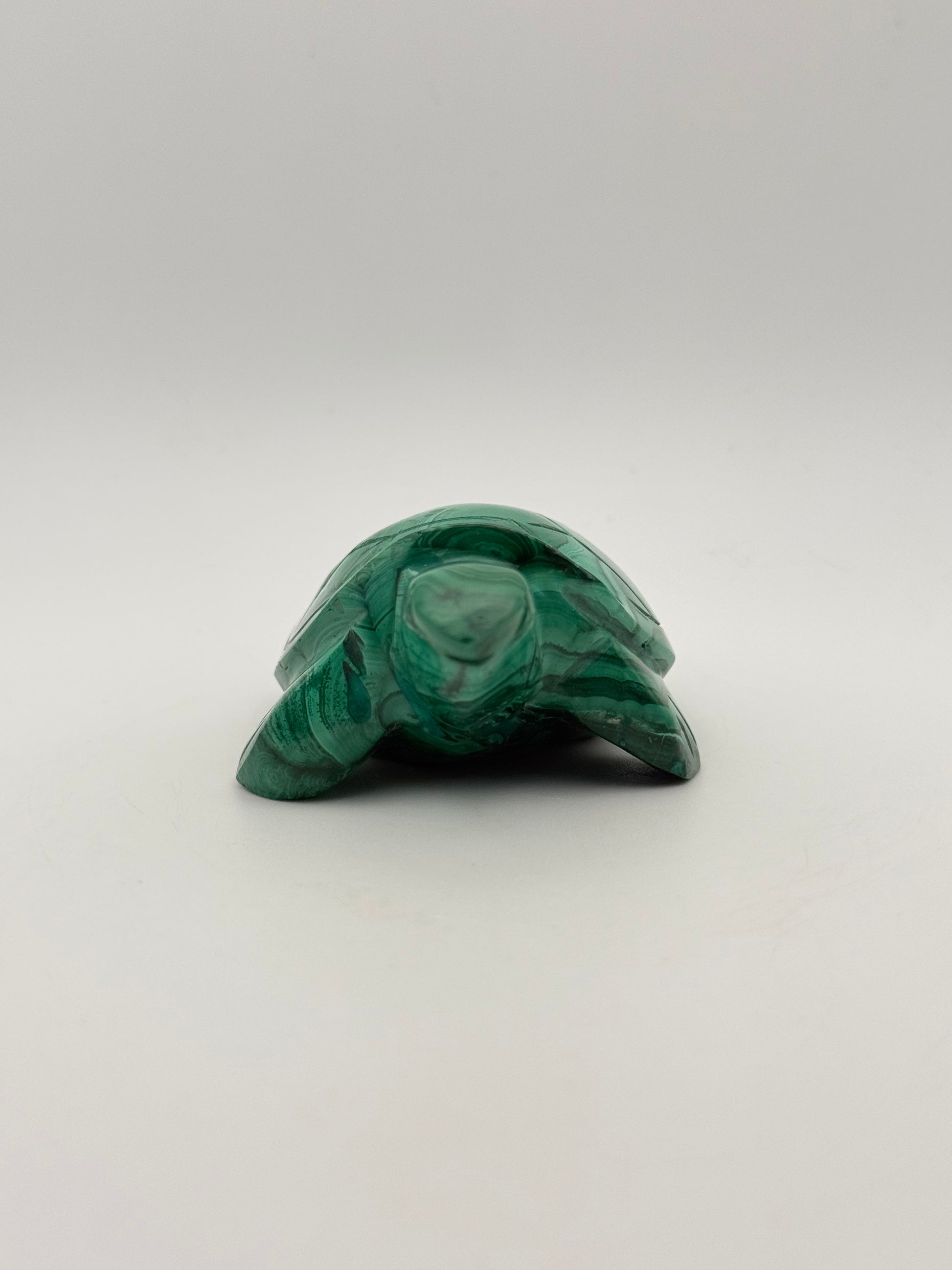 Vibrant green malachite stone carving of a turtle.
