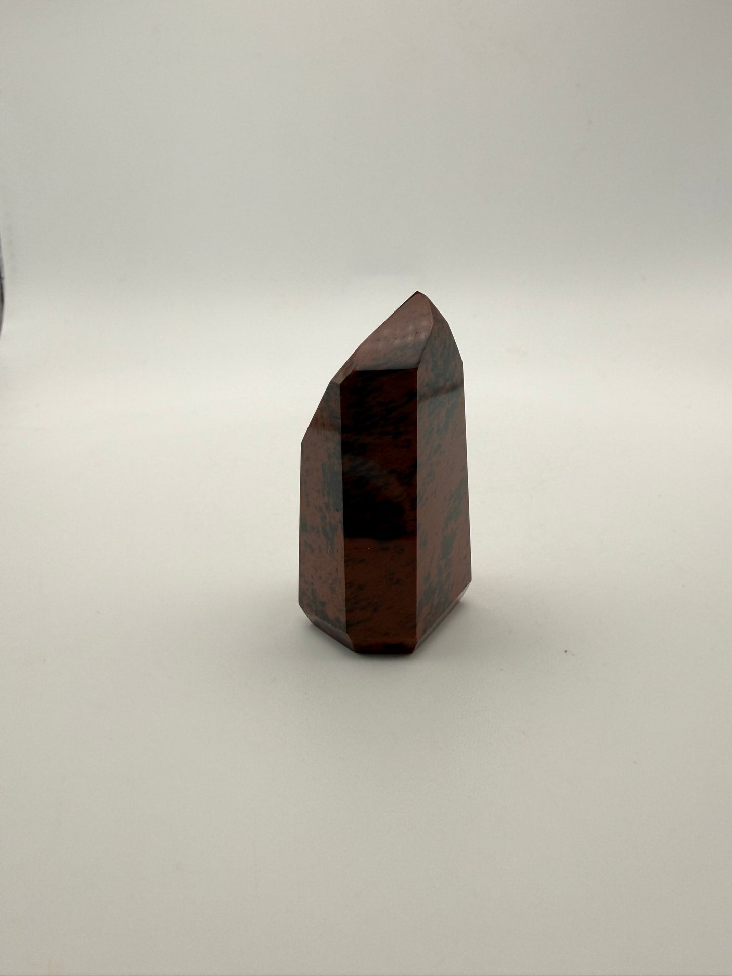 Polished mahogany obsidian tower with six sides.