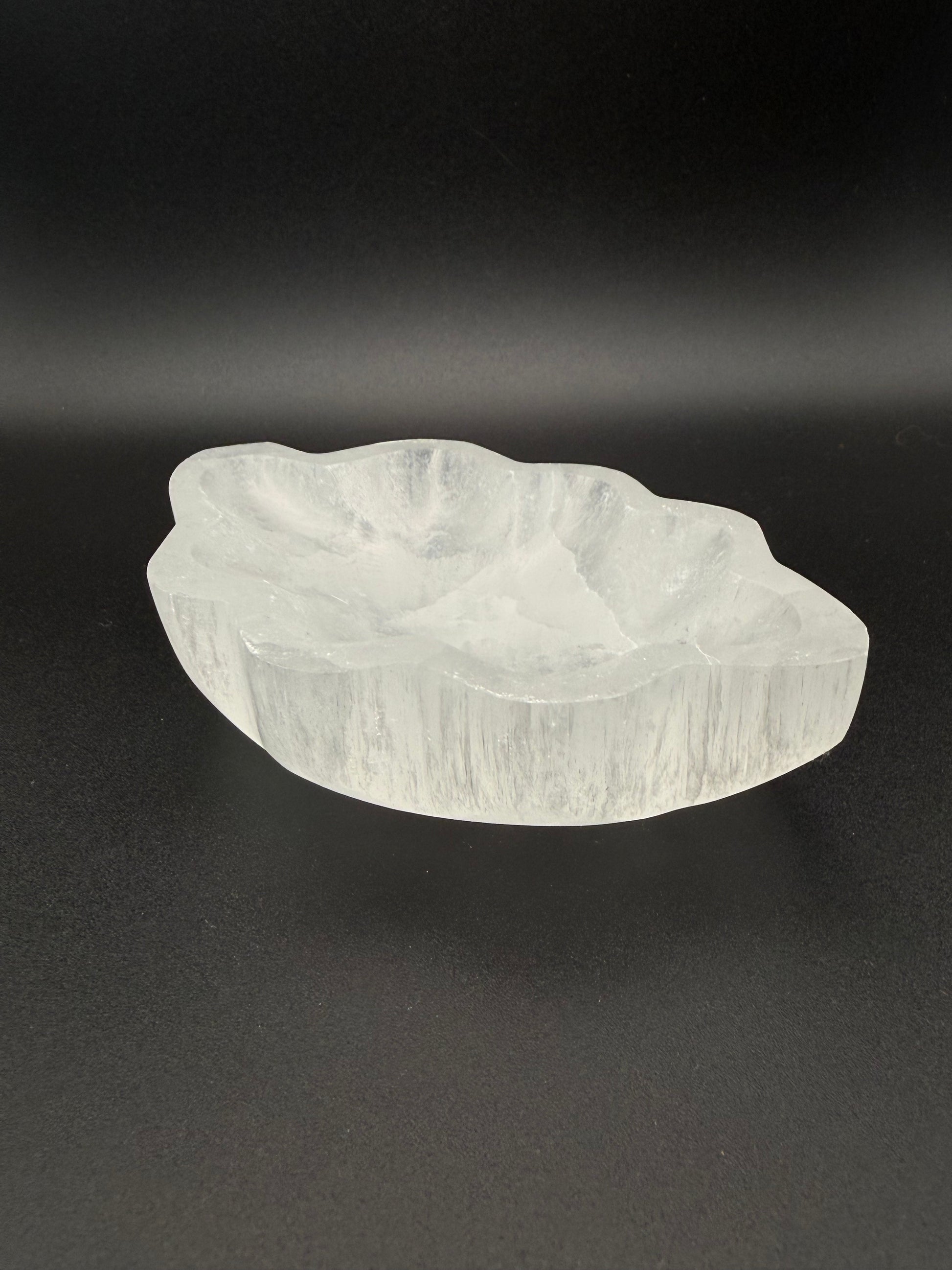 Selenite bowl in the shape of a leaf.