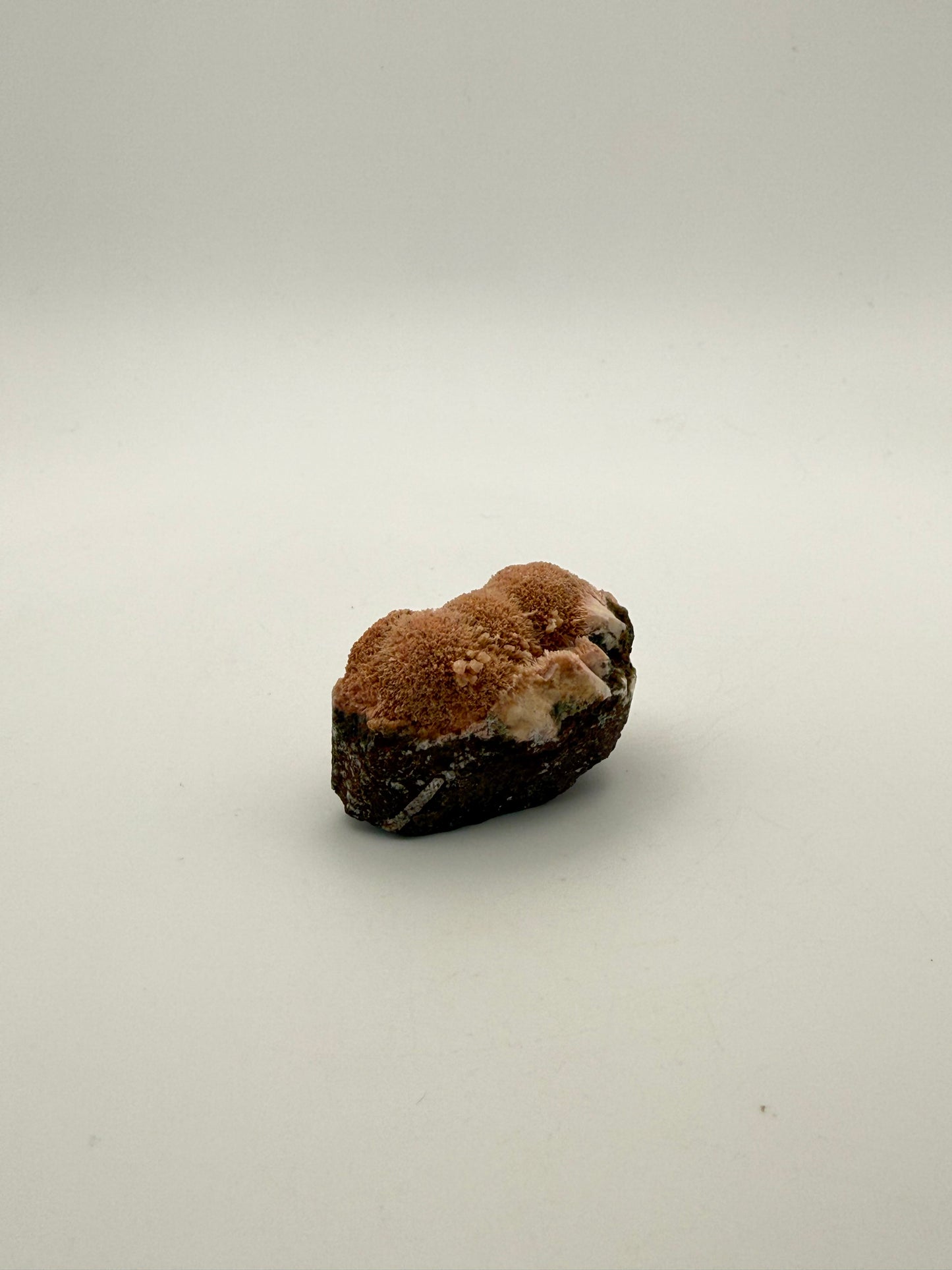 Raw Messolite crystal.